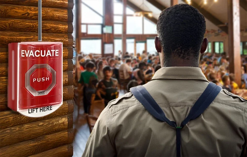 Camp councelor oversees campers with an activation button nearby.