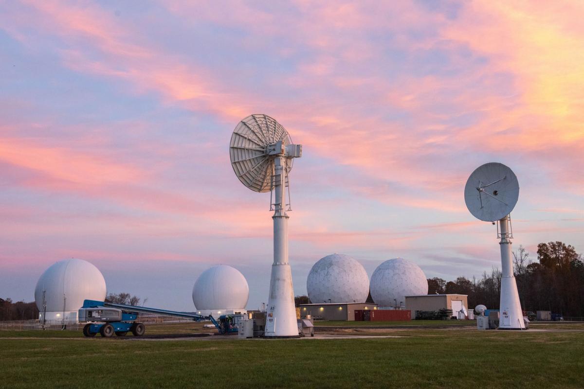 Blossom Point Tracking Facility antennas pointed skyward at sunset. NRL Photo by Emanuel Cavallaro.