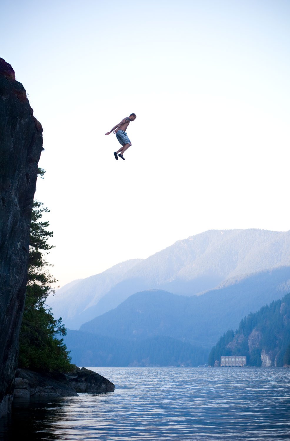 man-jumping-off-cliff-into-ocean-adventure-photography.jpg