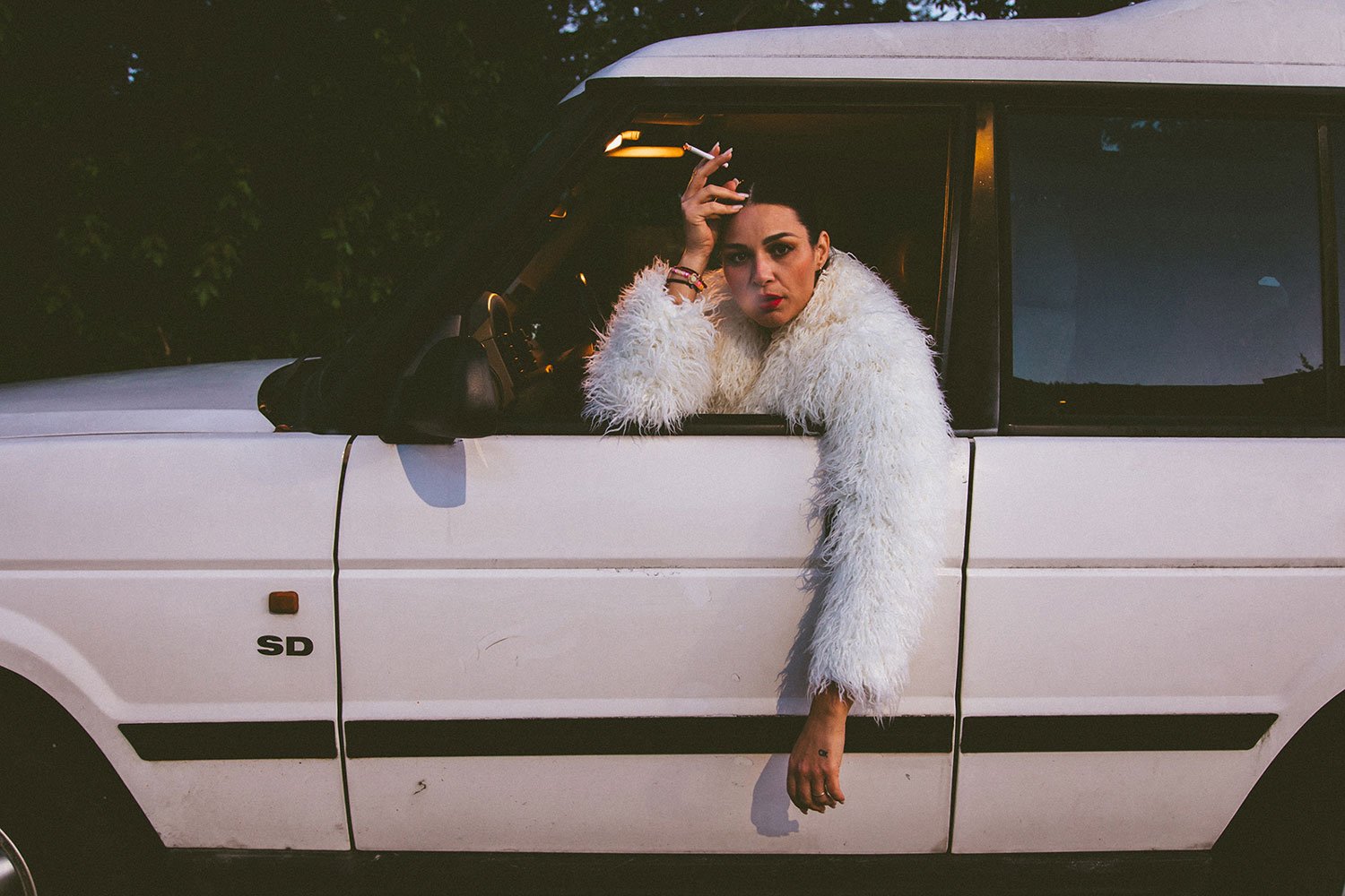 woman-hanging-out-of-car-window-blowing-smoke.jpg