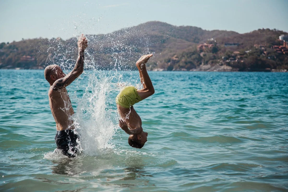adventure-family-photographer-dad-and-son-in-ocean-playing.jpg