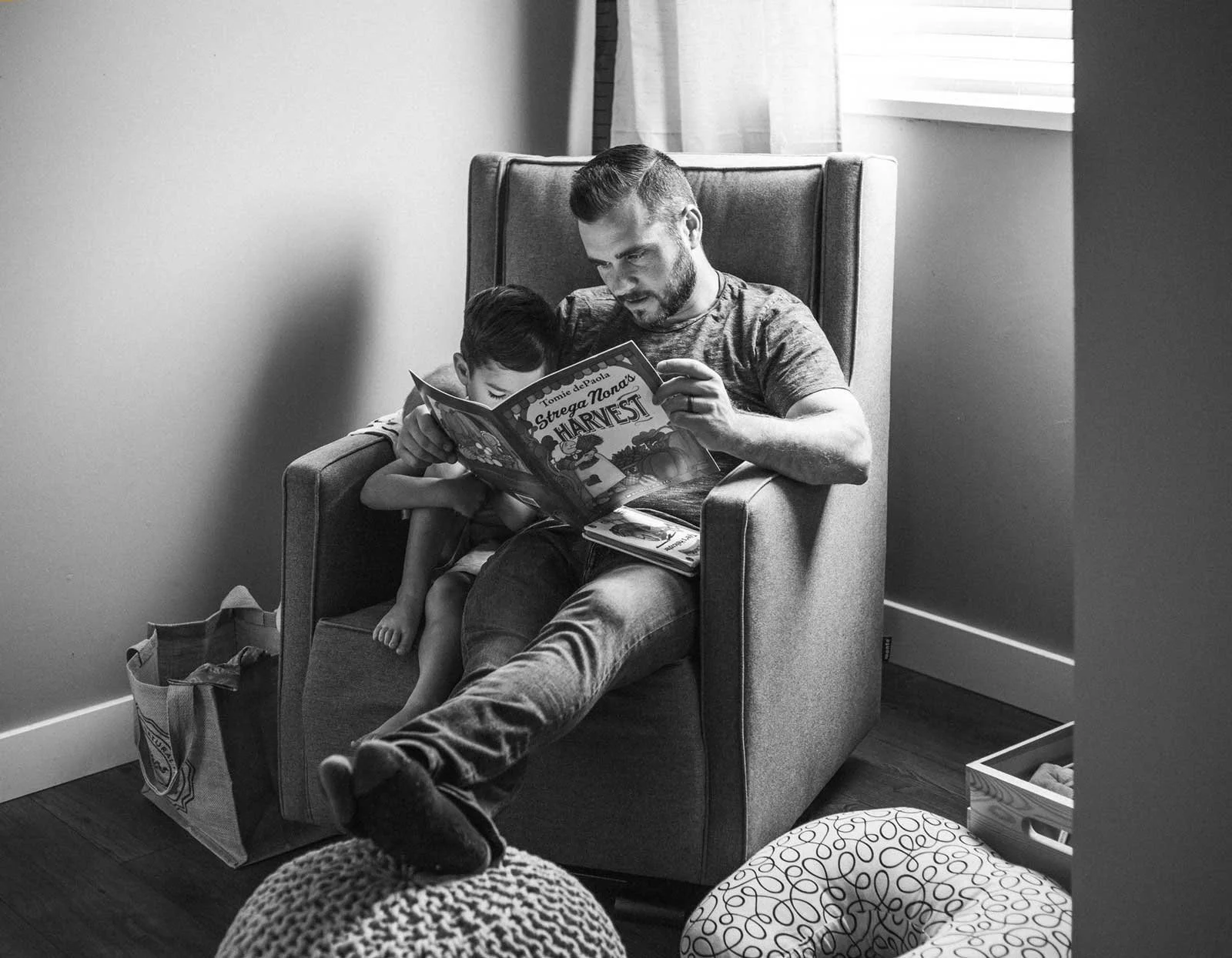 black-and-white-family-photography-dad-reading-to-son.jpg