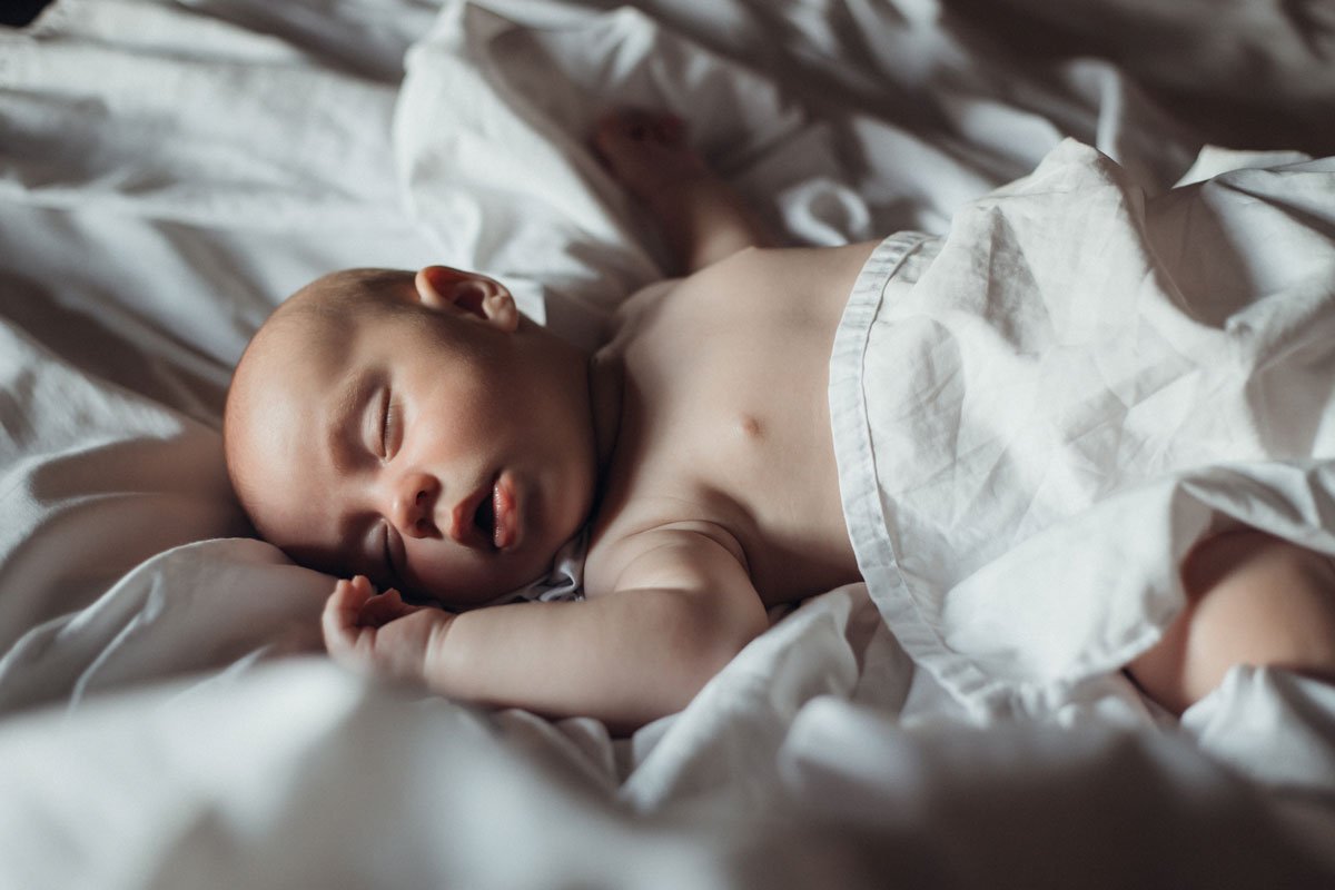 coquitlam-bc-newborn-lifestyle-photography-sleeping-baby-in-bed.jpg