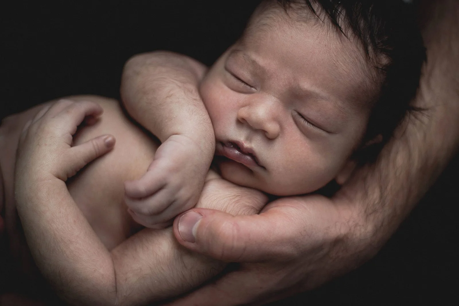 coquitlam-bc-newborn-photography-baby-in-parents-hands-closeup.jpg