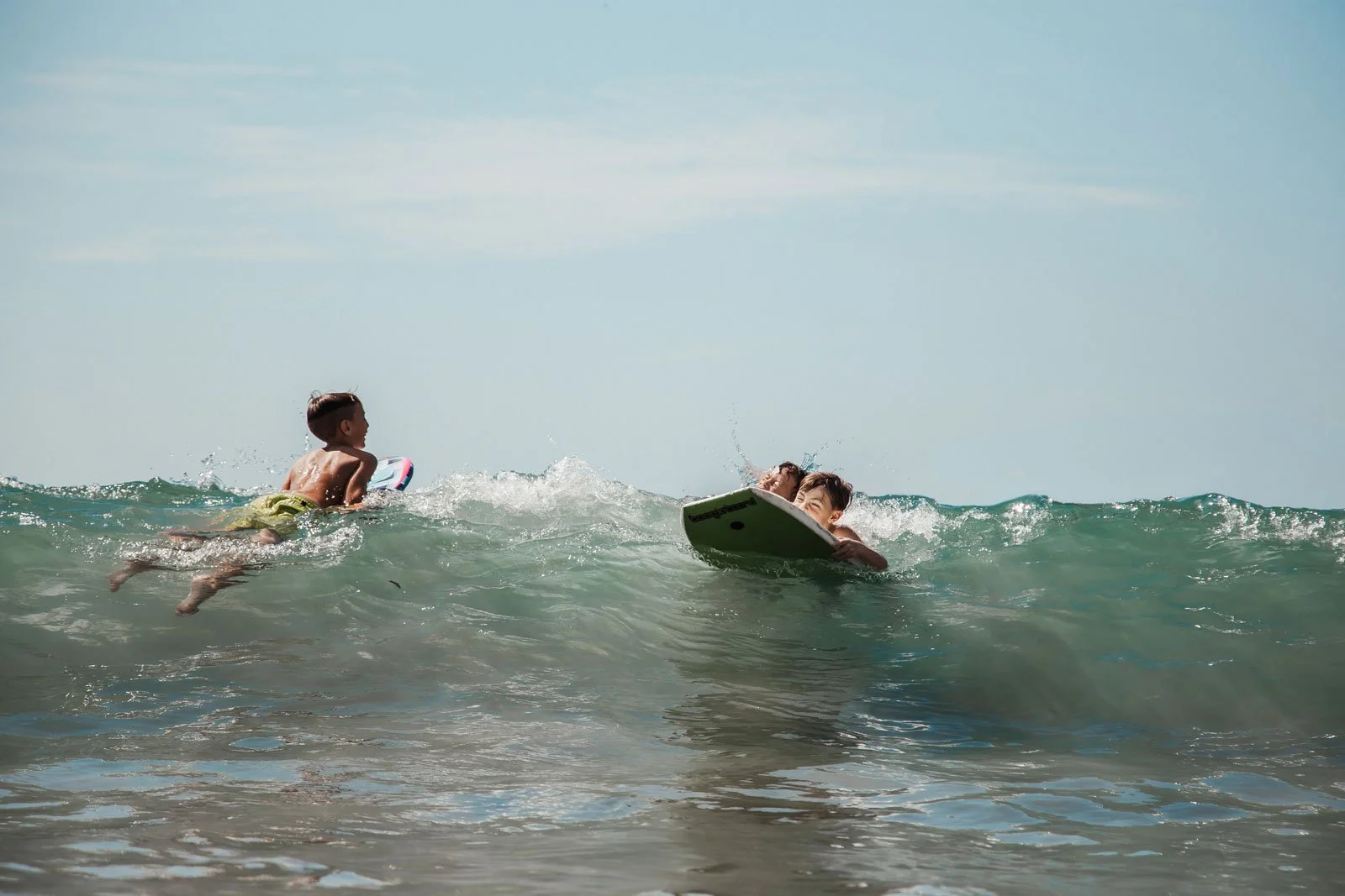 travel-family-photographer-kids-in-ocean-waves.jpg