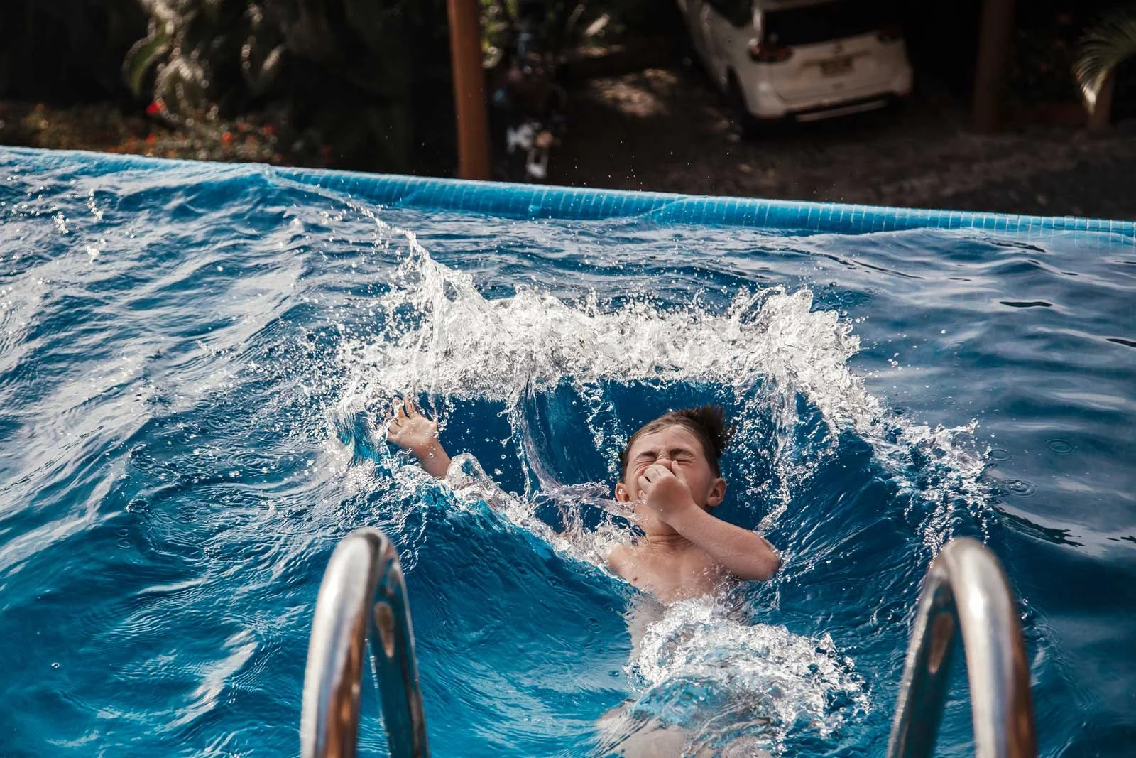 travel-family-photography-kid-jumping-into-pool.jpg