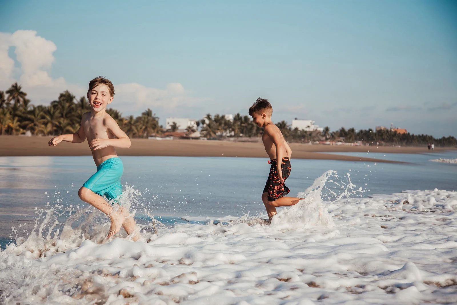 travel-family-photography-kids-running-in-ocean-waves.jpg
