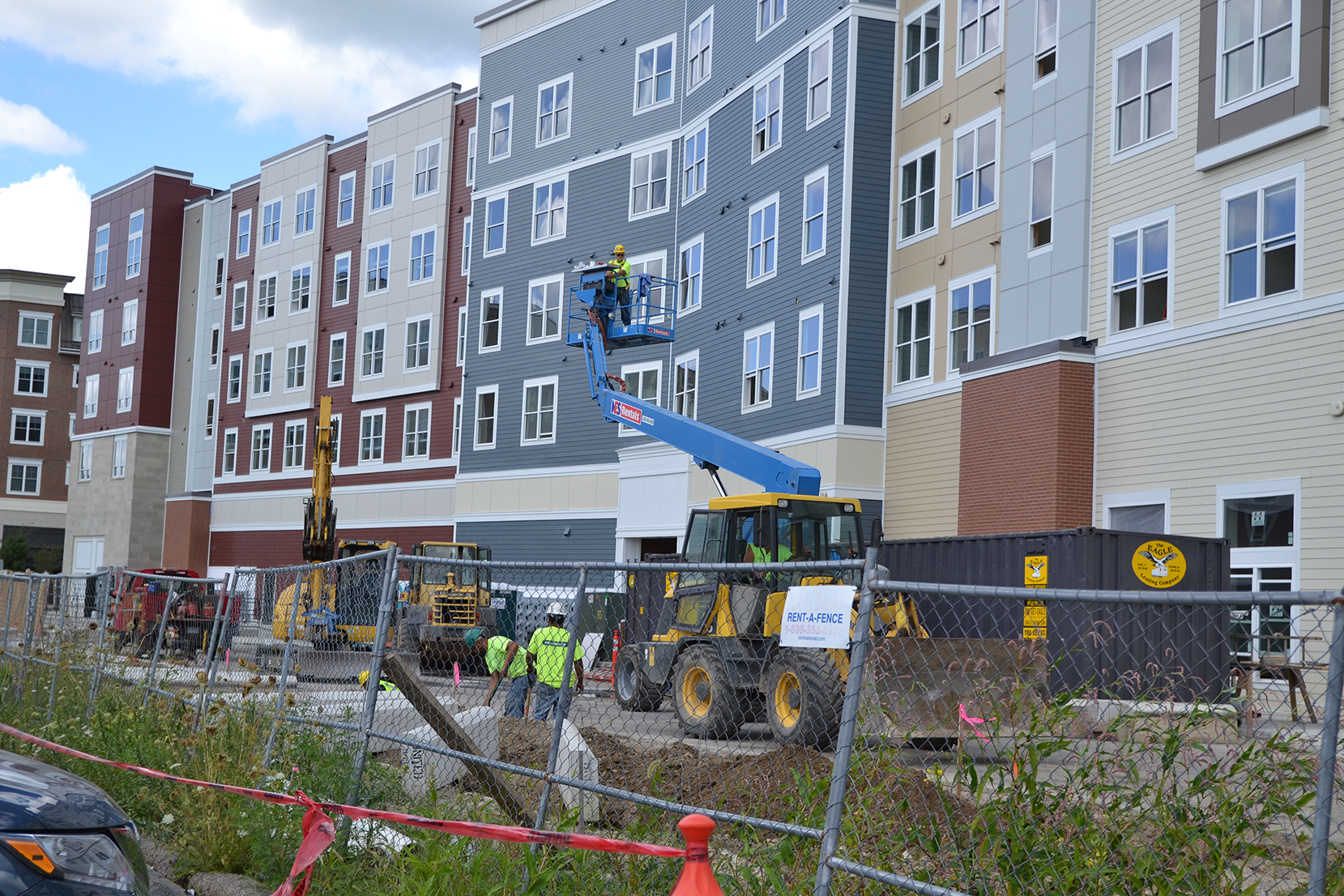 Construction crews are seen at The Oaks on the Square apartment complex in Storrs Center on Aug. 27, 2015. UConn students still awaiting apartments will be commuting or staying in hotels until the construction is completed. (Amar Batra/The Daily Campus)