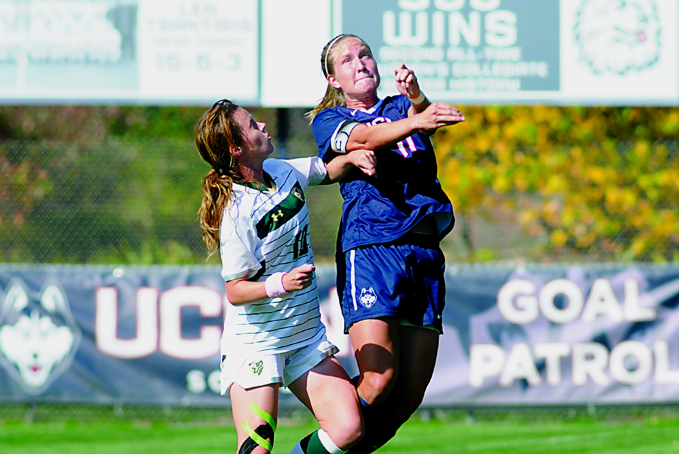 A UConn women's soccer player goes up for a header last season against South Florida at Joseph J. Morrone Stadium on Oct. 17, 2014. The Huskies defeated Navy 4-2 on Sunday to improve to 3-0 this season. (File Photo/The Daily Campus)