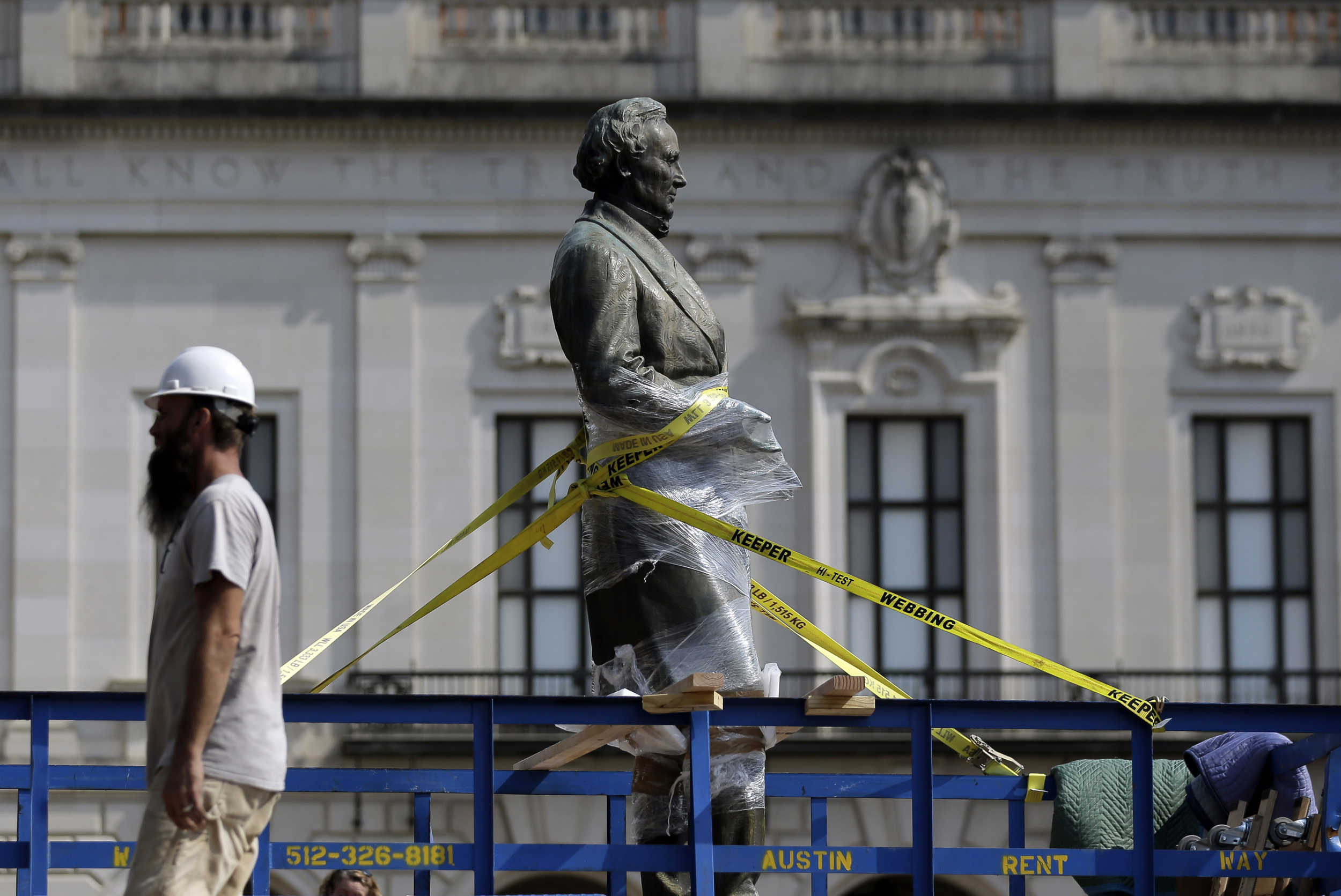A statue of Confederate President Jefferson Davis is moved from its location in front of the school's main tower the University of Texas campus, Sunday, Aug. 30, 2015, in Austin, Texas. The Davis statue, which has been targeted by vandals and had come under increasing criticism, will be moved and placed in the school's Dolph Briscoe Center for American History as part of an educational display. (Eric Gay/AP)