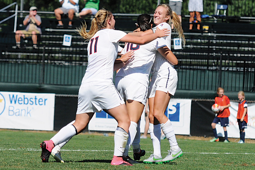 Members of the UConn women's soccer team celebrate with forward Rachel Hill (far right) after her late game winner against Harvard on Sunday, Sept. 6, 2015. The Huskies improved to 5-0 this season with the win over the Crimson. (Amar Batra/The Daily Campus)