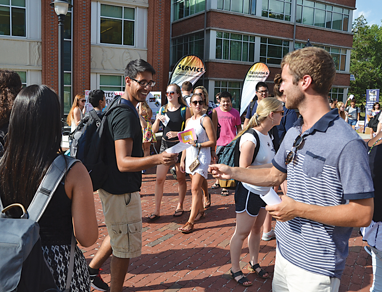 A student receives an informational handout during the fall Involvement Fair on Fairfield Way on Wednesday, Sept. 9, 2015. (Amar Batra/The Daily Campus)