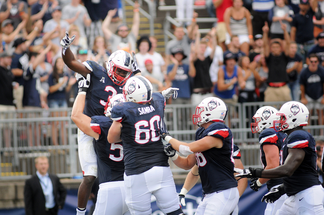 UConn running back Ron Johnson (3) celebrates with his team after scoring a 10-yard rushing touchdown in the second quarter to shorten Army's lead to one point. Johnson, a sophomore, finished the game with 39 yard rushing on 18 attempts. (Bailey Wright/The Daily Campus)