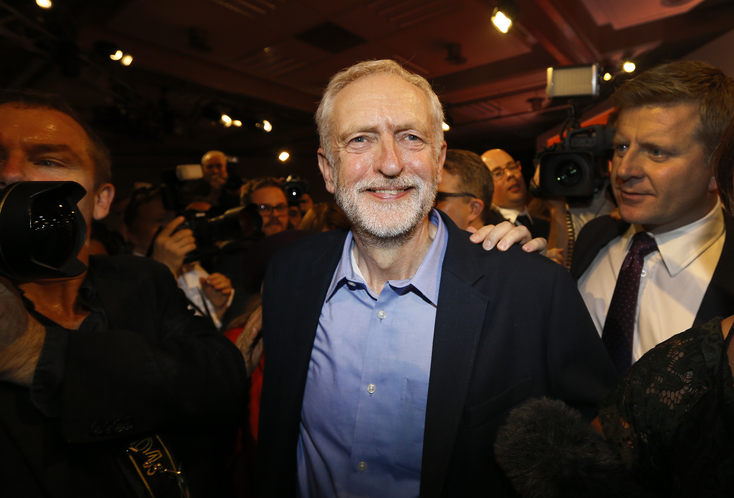 Jeremy Corbyn smiles as he leaves the stage after he is announced as the new leader of The Labour Party during the Labour Party Leadership Conference in London, Saturday, Sept. 12, 2015. Corbyn will now lead Britain's main opposition party. (Kirsty Wigglesworth/AP)