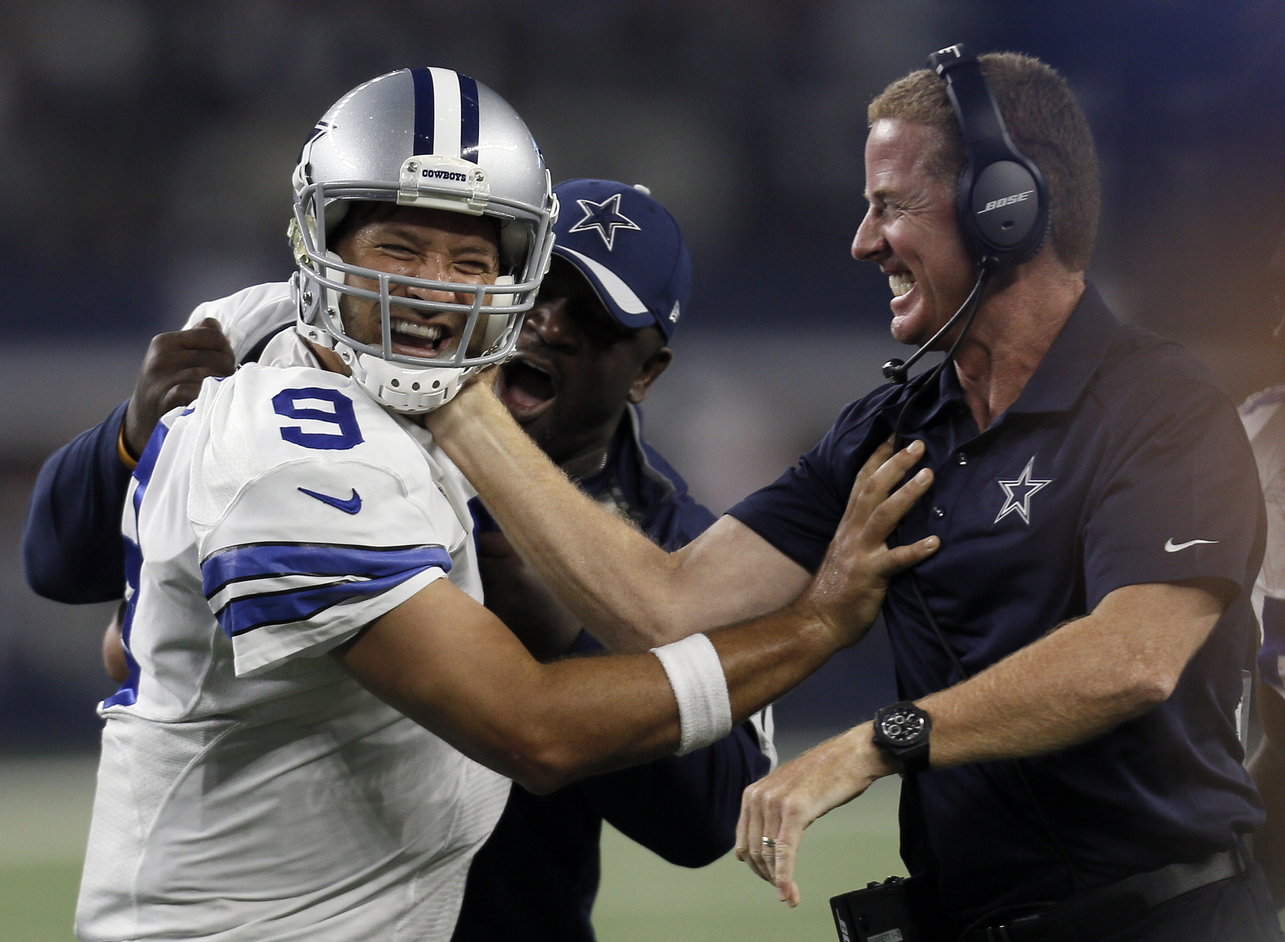 Dallas Cowboys quarterback Tony Romo and head coach Jason Garrett celebrate a last minute touchdown pass to tight end Jason Witten (82) to win against the New York Giants during the second half of an NFL football game Sunday, Sept. 13, 2015, in Arlington, Texas. Cowboys won 27-26. (Brandon Wade/AP)