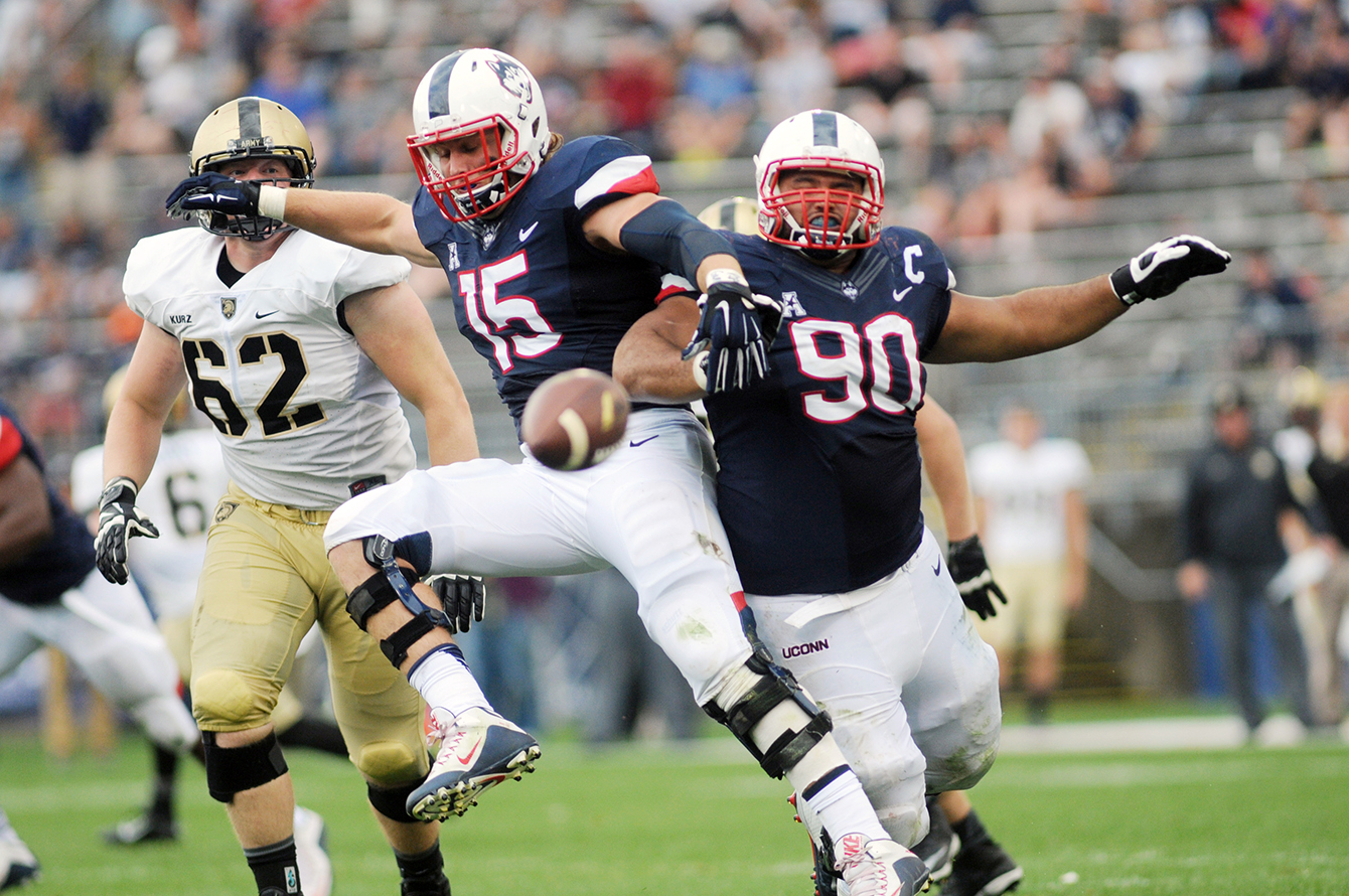 UConn football sophomore linebacker Luke Carrezola (15) and redshirt senior defensive lineman Julian Campenni (90) are pictured during the Huskies' game against Army at Pratt & Whitney Stadium at Rentschler Field in East Hartford, Connecticut on Saturday, Sept. 12, 2015. (Bailey Wright/The Daily Campus)