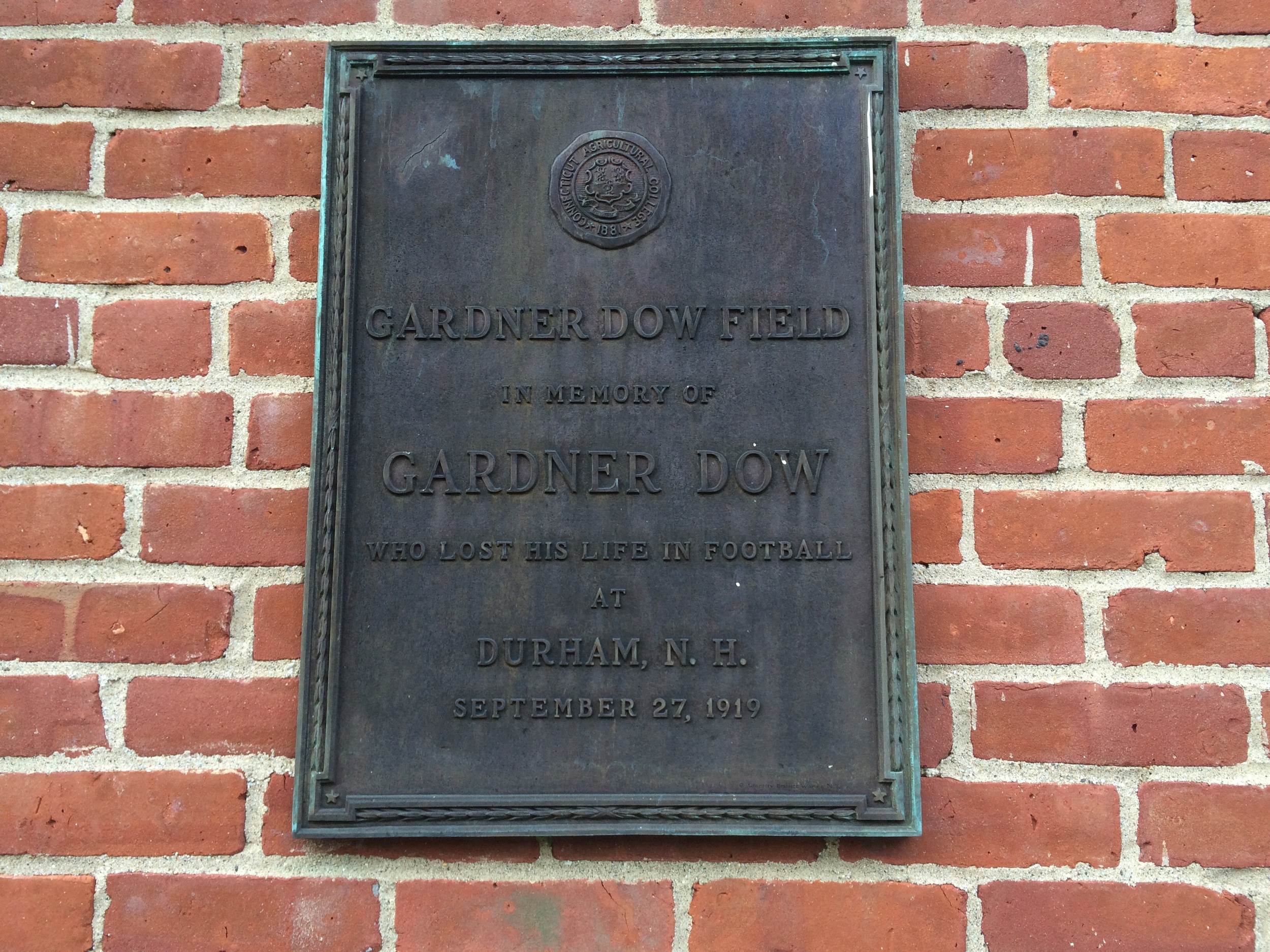 In this photo, the plaque memorializing Gardner Dow Field is seen behind the Hawley Armory on the UConn campus in Storrs, Connecticut. (Courtesy/Dan Madigan)