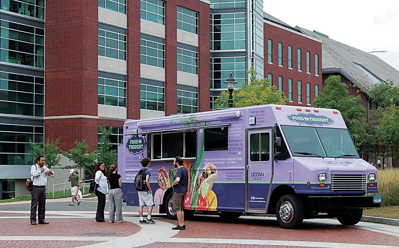 Students and staff members stand in front of the Food for Thought food truck on Fairfield Way. The truck is currently serving crickets as a taco topping. (Ashley Maher/The Daily Campus)