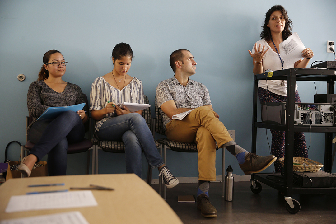 Anna Reyna, right, supervisor of the counseling department at The Door, teaches a class on adolescent development at the youth services organization, in New York. New York City is embarking on a $30 million plan to prepare to staffers at social service organizations to screen people for possible psychological problems, provide information and try to motivate them to make changes in their lives. (Seth Wenig/AP)
