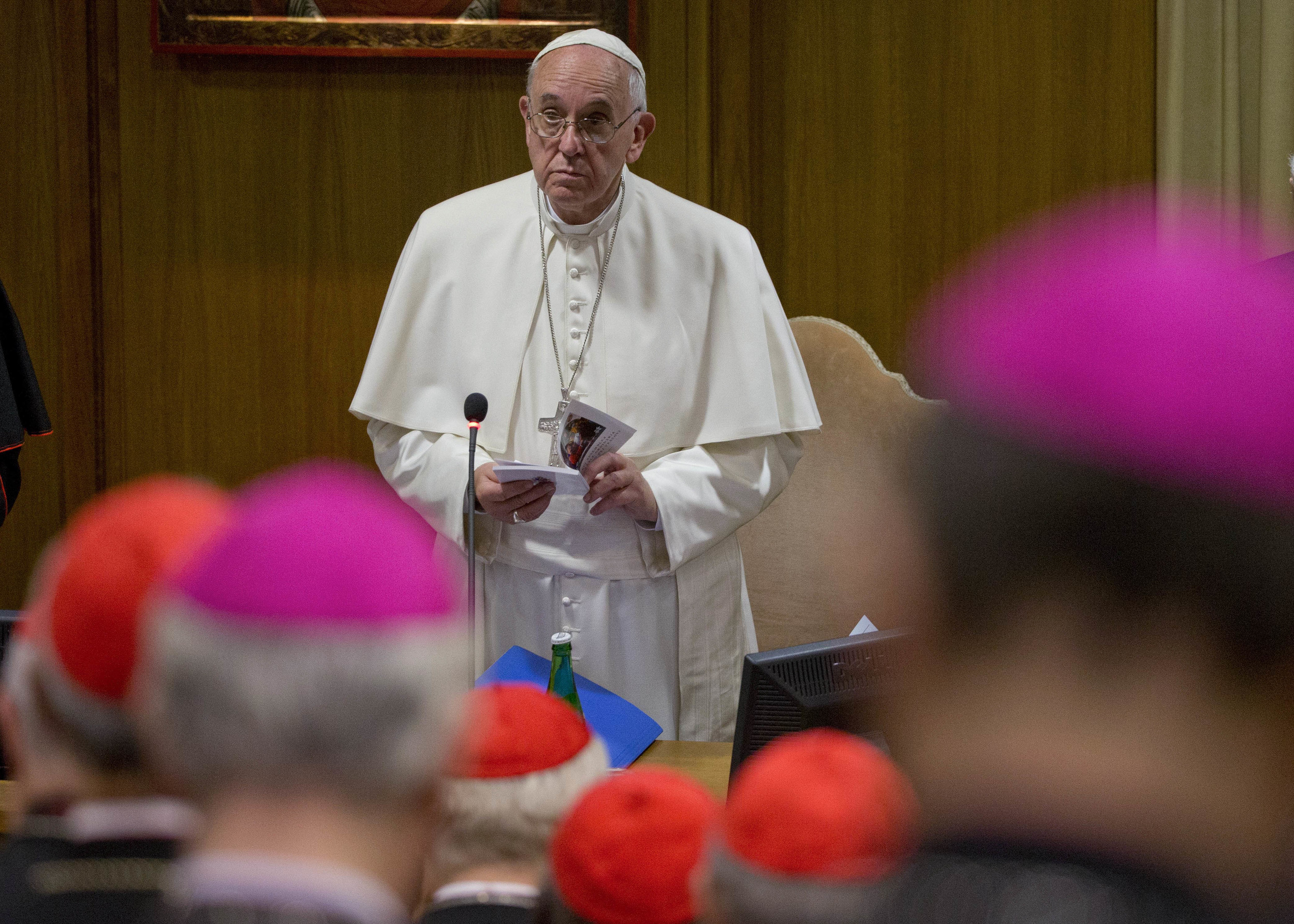 Pope Francis holds a prayer book as he opens a morning session of the two-week long Synod of bishops, at the Vatican, Tuesday, Oct. 6, 2015. (Alessandra Tarantino/AP)
