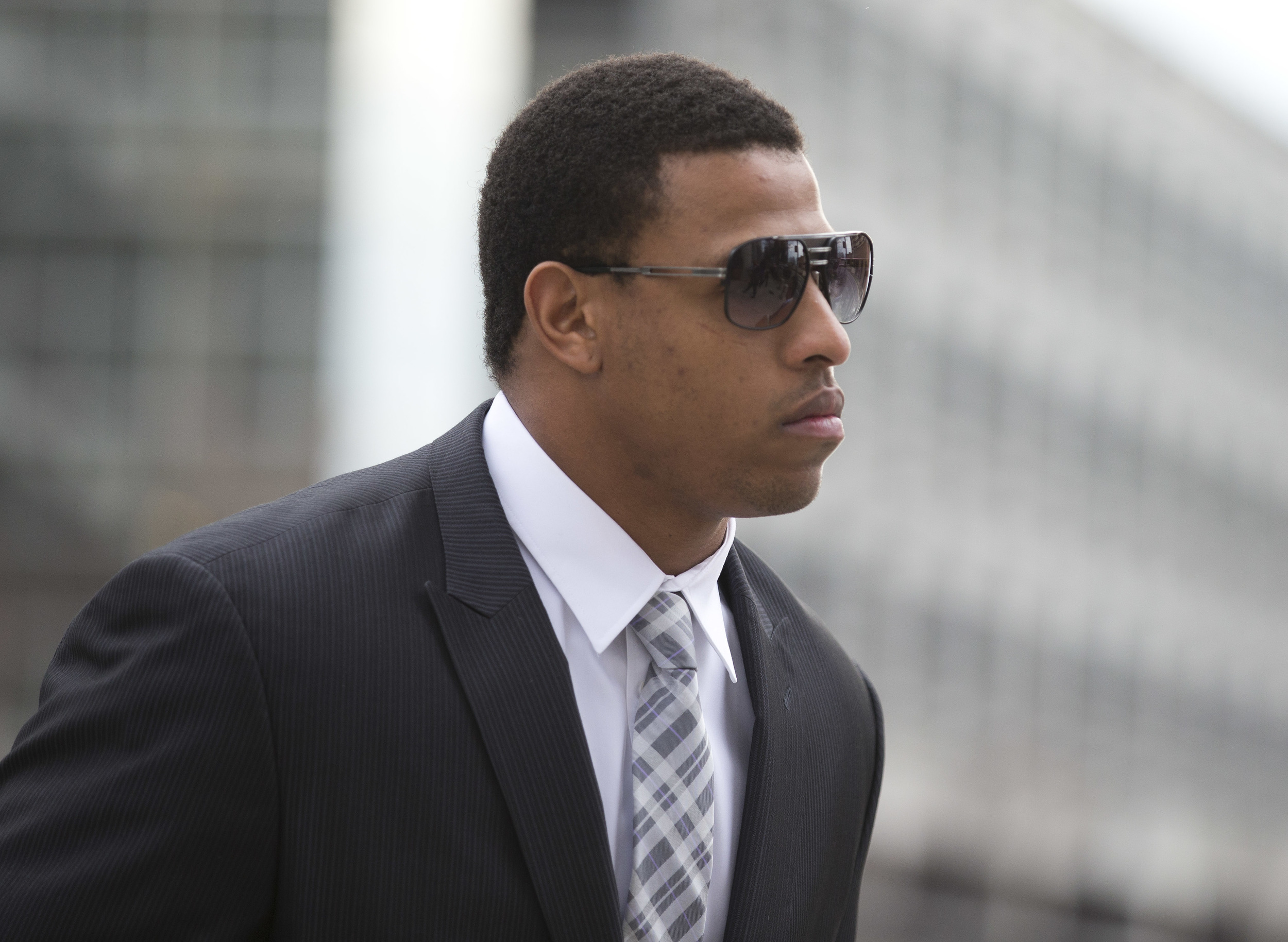 In this Feb. 9, 2015, file photo, Carolina Panthers' defensive end Greg Hardy arrives at the Mecklenburg County Courthouse on the first day of his domestic violence appeal trial in Charlotte, N.C. Hardy has returned from a four-game suspension over his role in a domestic violence case. If Hardy plays for the Cowboys on Sunday, Oct. 11, 2015, against Super Bowl champion New England (3-0), it will be his first game since last year's season opener with Carolina. (Chris Keane, File/AP)