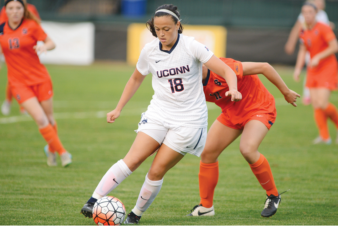 UConn redshirt junior forward Stephanie Ribeiro dribbles away from a Syracuse defender during the Huskies' game at Joseph J. Morrone Stadium in Storrs, Connecticut on Sept. 3. 2015. Ribeiro scored the game's lone goal to lift UConn over the Orange 1-0. (Jason Jiang/The Daily Campus)