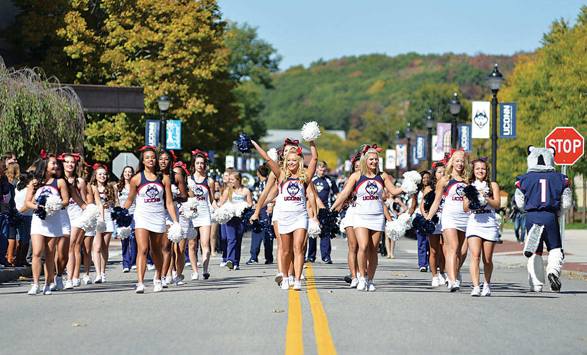 In this photo, UConn cheerleaders march down Hillside Road during the Homecoming Parade on Sunday, Oct. 11, 2015. (Jason Jiang/The Daily Campus)
