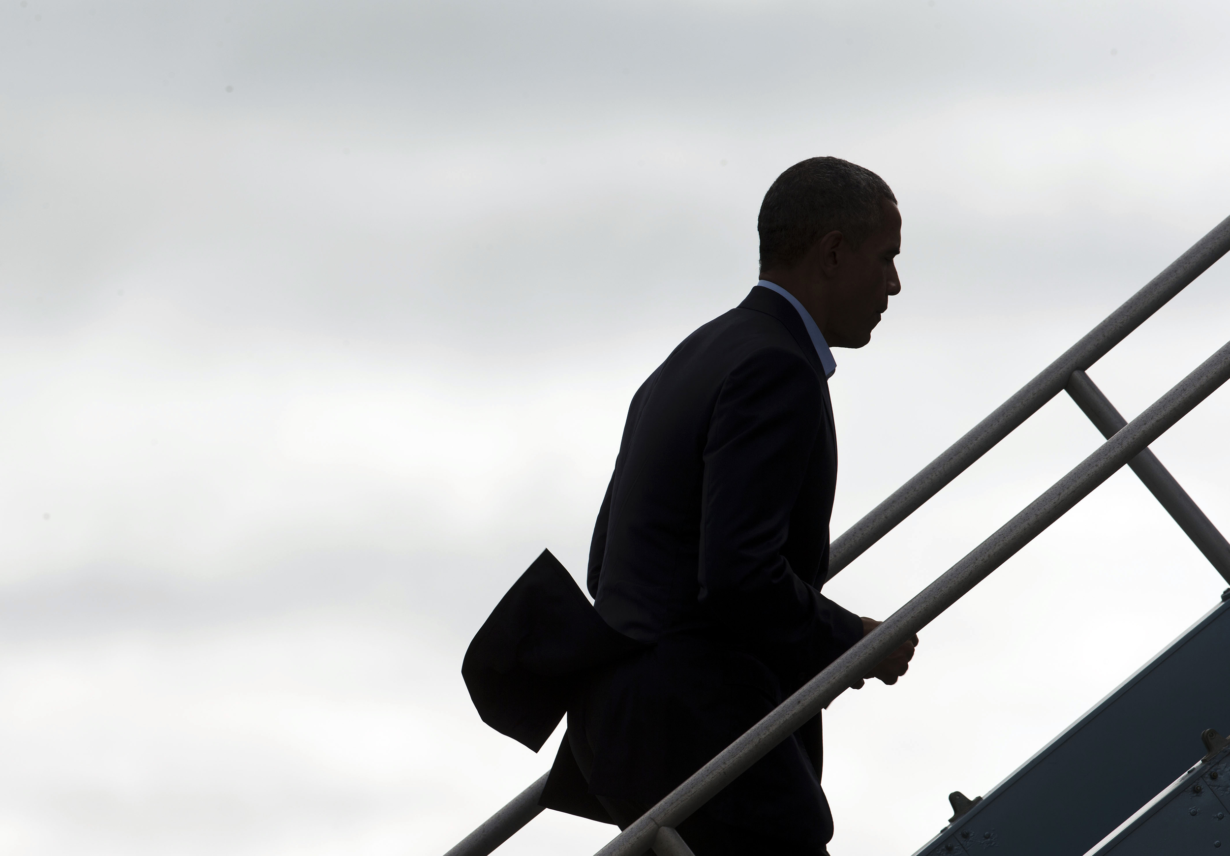 President Barack Obama goes up the stairs as he boards Air Force One at San Francisco International Airport, Saturday, Oct. 10, 2015 in San Francisco. Obama is on a four-day West Coast tour that includes democratic fundraisers along the way. (Pablo Martinez Monsivais/AP)