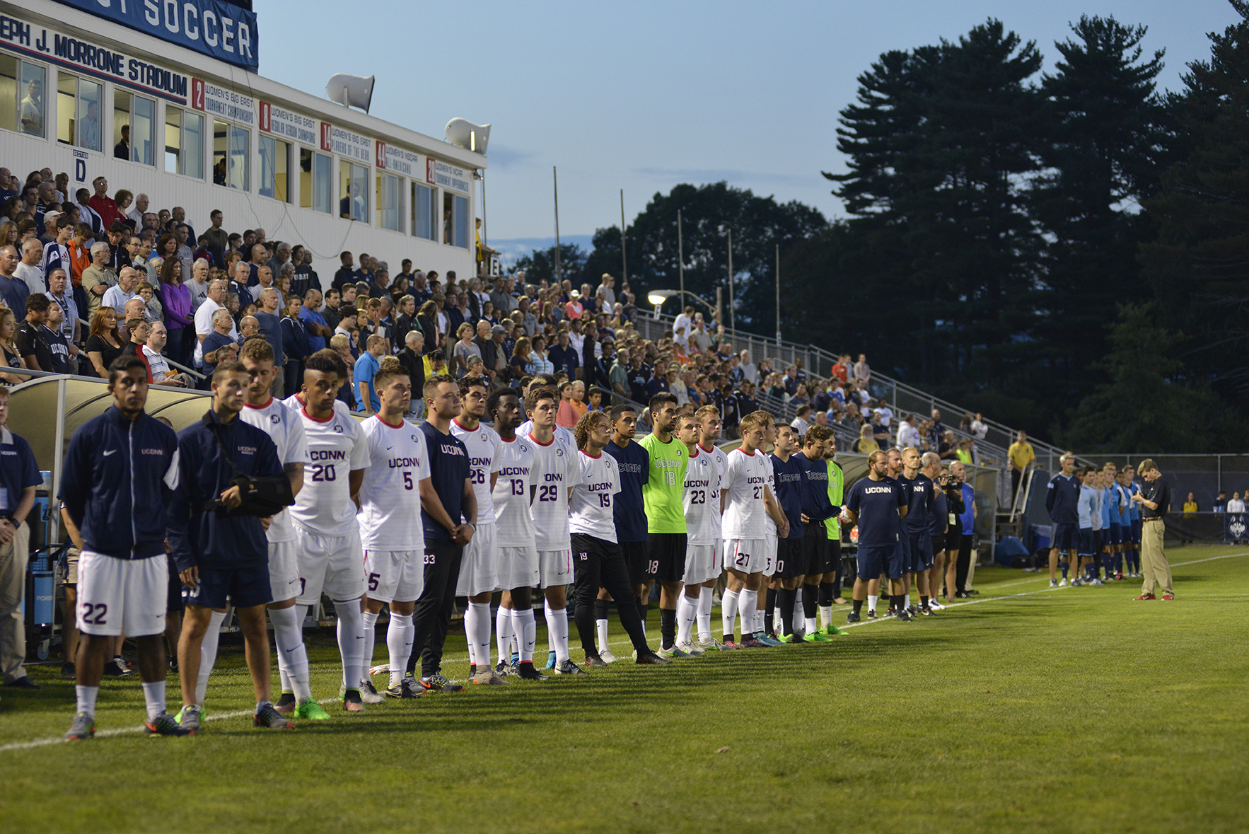 UConn men's soccer team players, coaches and staff stand on the sideline at Joseph J. Morrone Stadium prior to the team's game against Rhode Island in Storrs, Connecticut on Saturday, Sept. 19, 2015. (Jason Jiang/The Daily Campus)