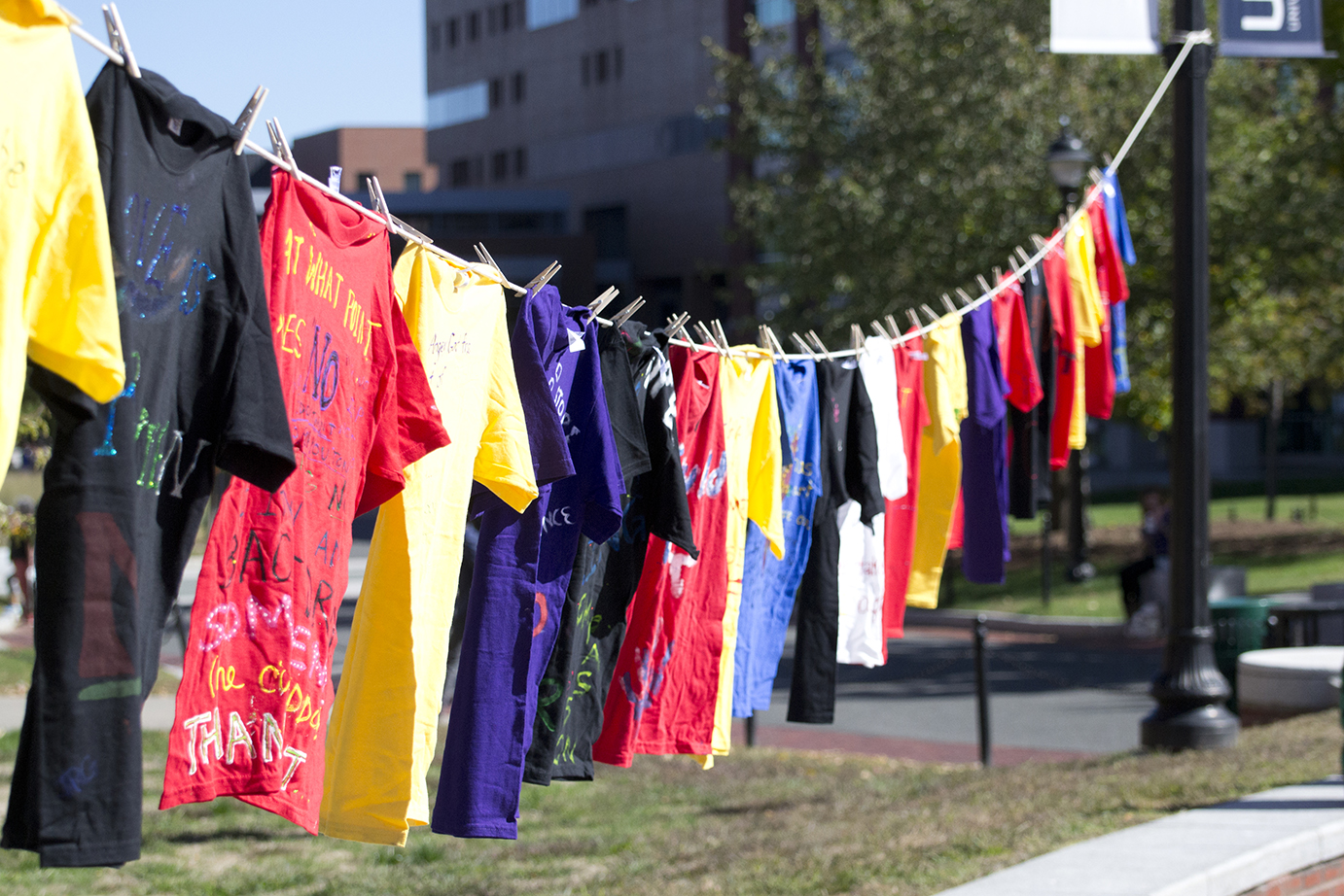 Shirts are seen hanging on a clothesline outside of the UConn Student Union on Fairfield Way on Monday, Oct. 12, 2015. The shirts commemorate victims and honor the survivors of sexual assault. (Rebecca Newman/The Daily Campus)