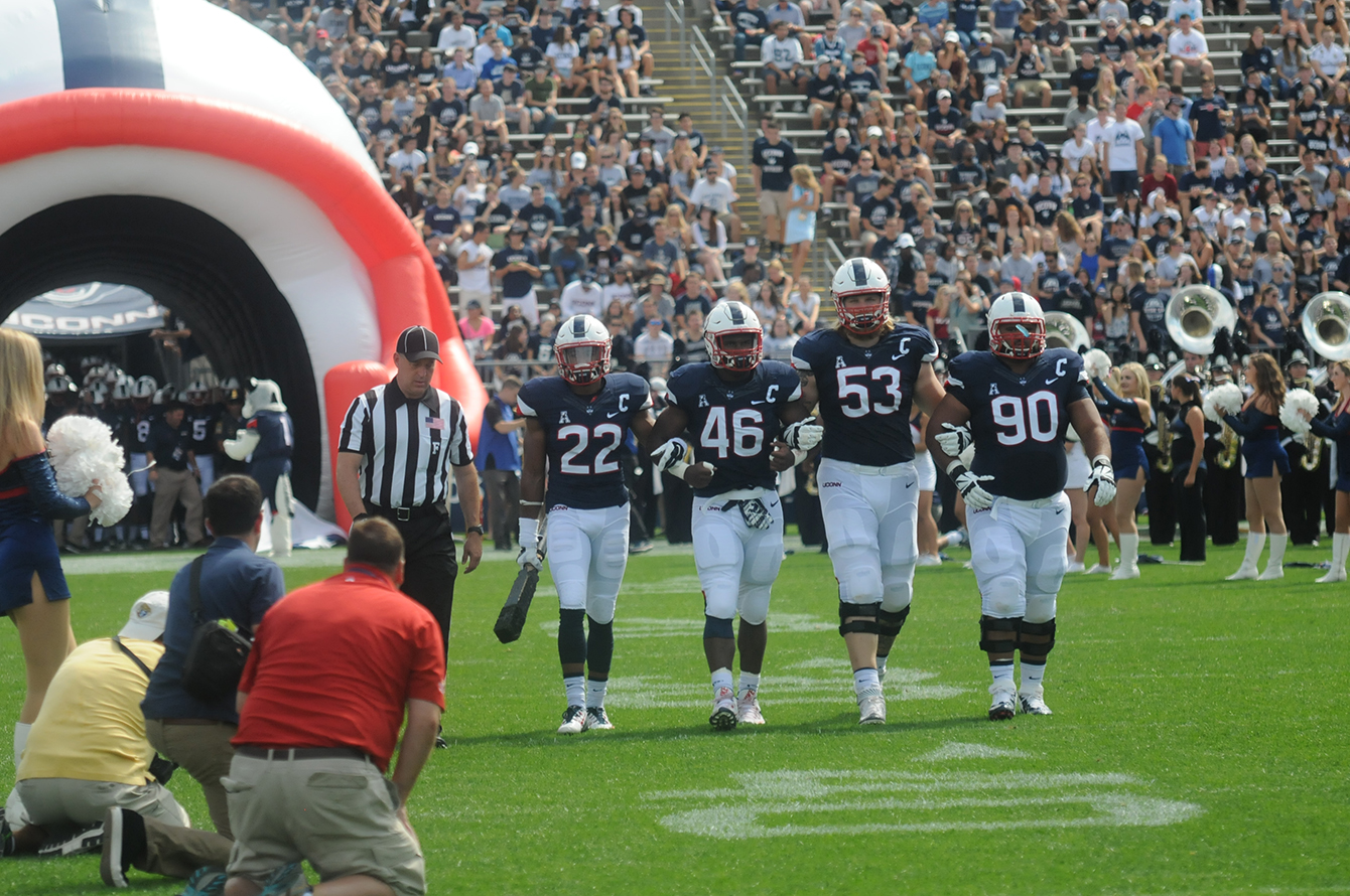 UConn's captains lead the team out of the tunnel prior to kicking off their game against Army at Pratt & Whitney Stadium at Rentschler Field in East Hartford, Connecticut on Saturday, Sept. 12, 2015. (Bailey Wright/The Daily Campus)