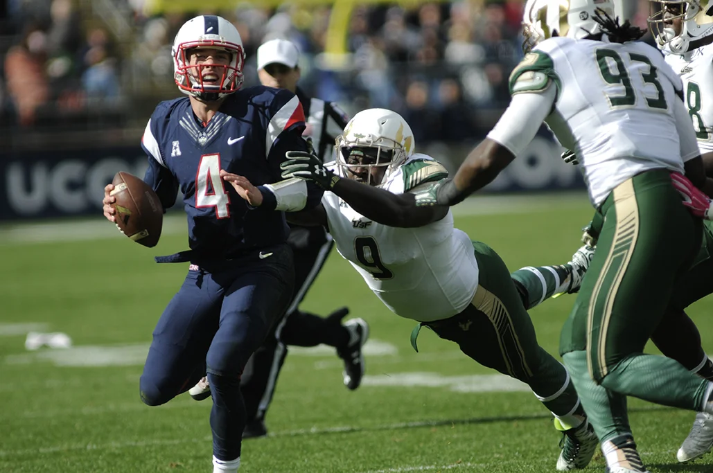 UConn quarterback Bryant Shirreffs under pressure against University of South Florida at UConn's homecoming football game on Oct. 17, 2015.