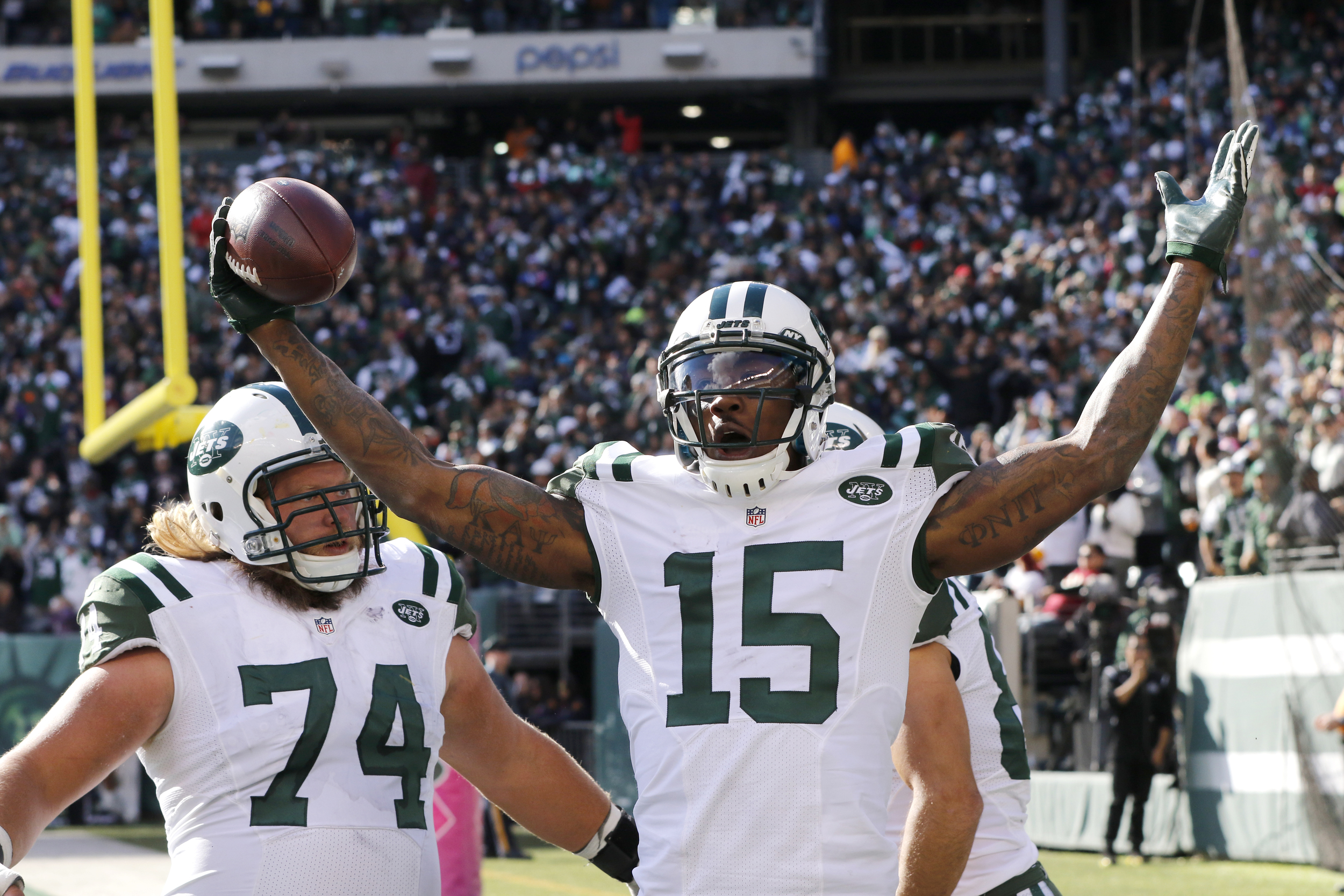 New York Jets wide receiver Brandon Marshall (15) celebrates with teammates Nick Mangold (74) and Eric Decker (87) after scoring on a touchdown pass from quarterback Ryan Fitzpatrick, not pictured, during the second half of an NFL football game against the Washington Redskins, Sunday, Oct. 18, 2015, in East Rutherford, N.J. (Gary Hershorn/AP)