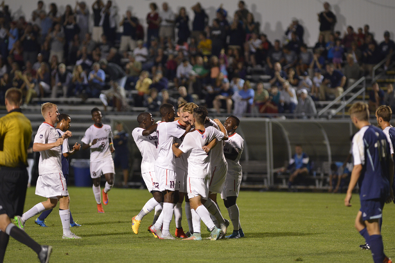 The UConn men's soccer team celebrates with freshman forward Frederik Jonsson after he scored the go-ahead goal against Rhode Island at Joseph J. Morrone Stadium in Storrs, Connecticut on Saturday, Sept. 19, 2015. (Jason Jiang/The Daily Campus)