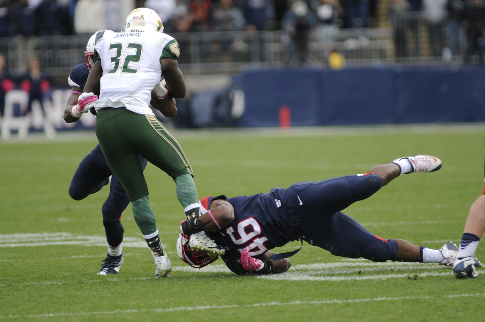 UConn linebacker Marquise Vann tackles South Florida D'Ernest Johnson during the Huskies' game against USF at Pratt & Whitney Stadium at Rentschler Field in East Hartford, Connecticut on Saturday, Oct. 17, 2015. (Bailey Wright/The Daily Campus)