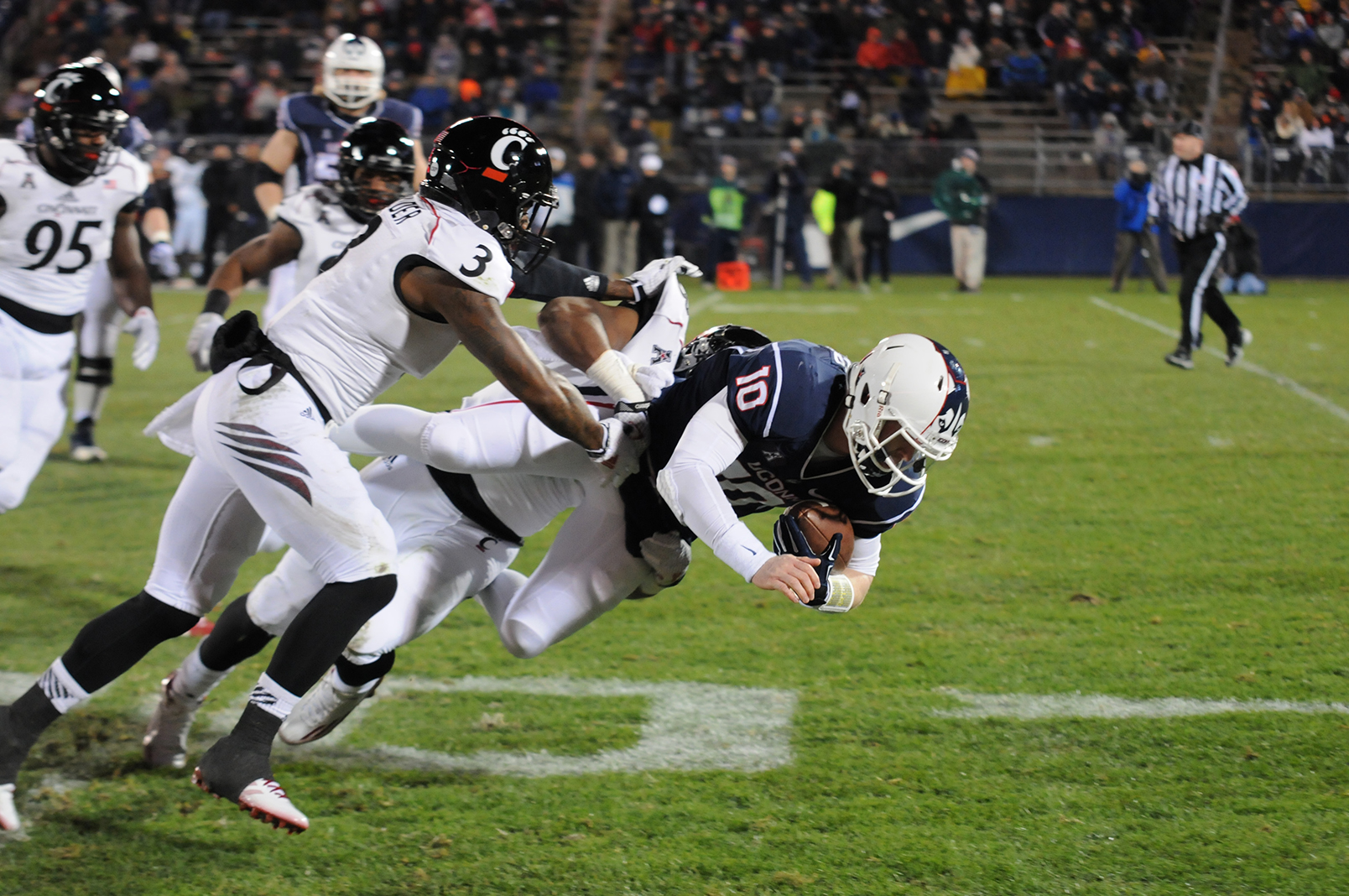 Quarterback Chandler Whitmer dives forward for UConn in last season's 41-0 loss against Cincinnati. The Huskies will take on the Bearcats this Saturday. (File Photo/Daily Campus)