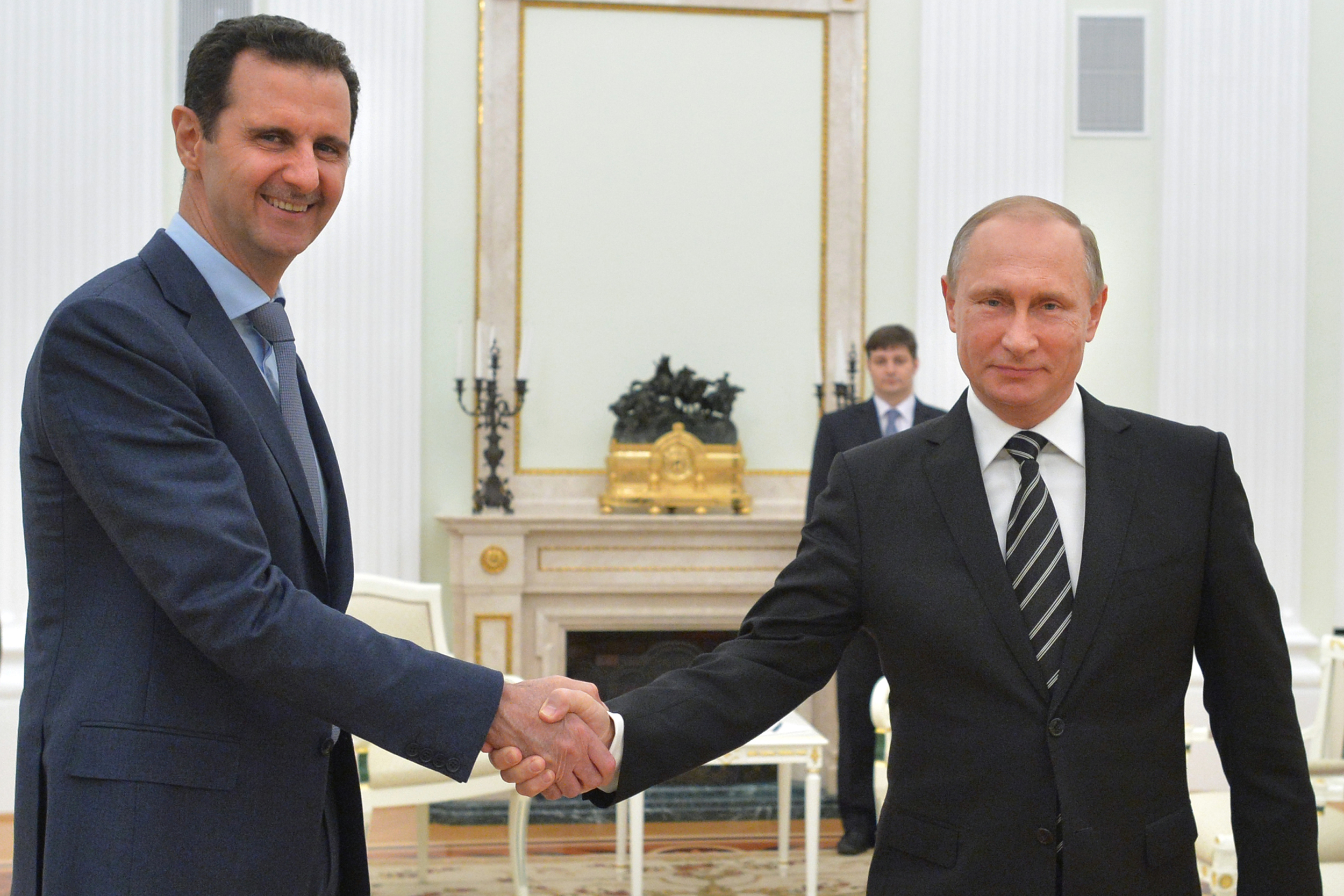 In this photo taken on Tuesday, Oct. 20, 2015, Russian President Vladimir Putin, right, shakes hand with Syria's President Bashar al-Assad in the Kremlin in Moscow, Russia. (Alexei Druzhinin, RIA-Novosti, Kremlin Pool Photo via AP)