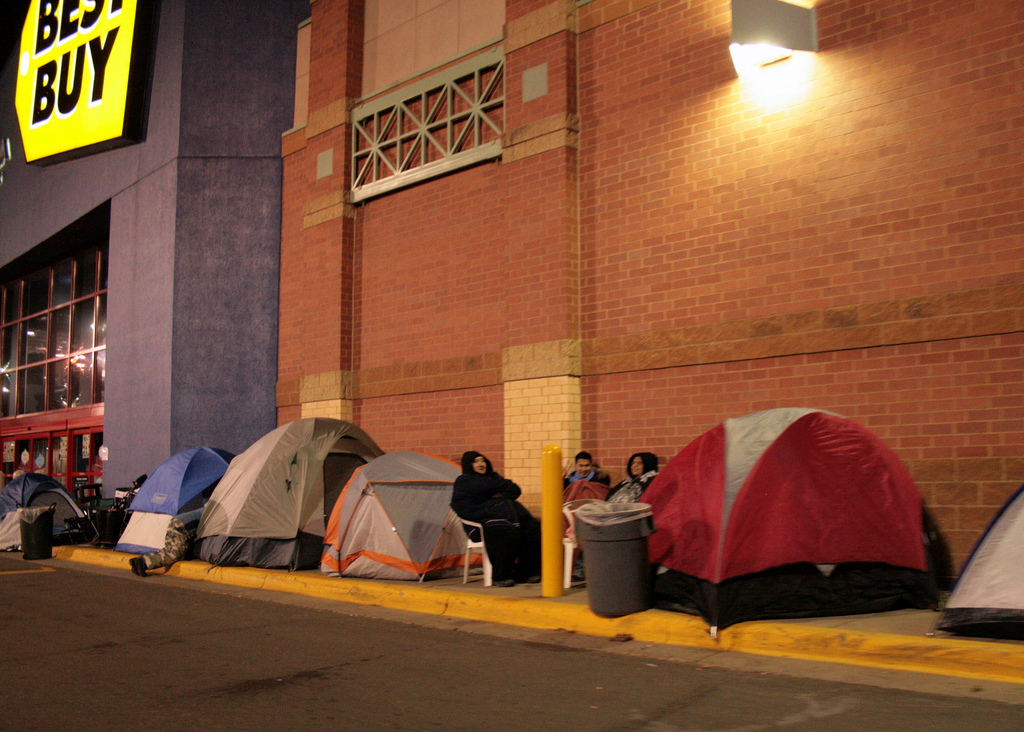 Customers set up camp outside of Best Buy on Thanksgiving night to stake out territory before Black Friday begins at 5 a.m. the following morning. REI has opted out of Black Friday this year, instead urging customers to go outside with their #OptOutside campaign. (David Haines/Flickr)