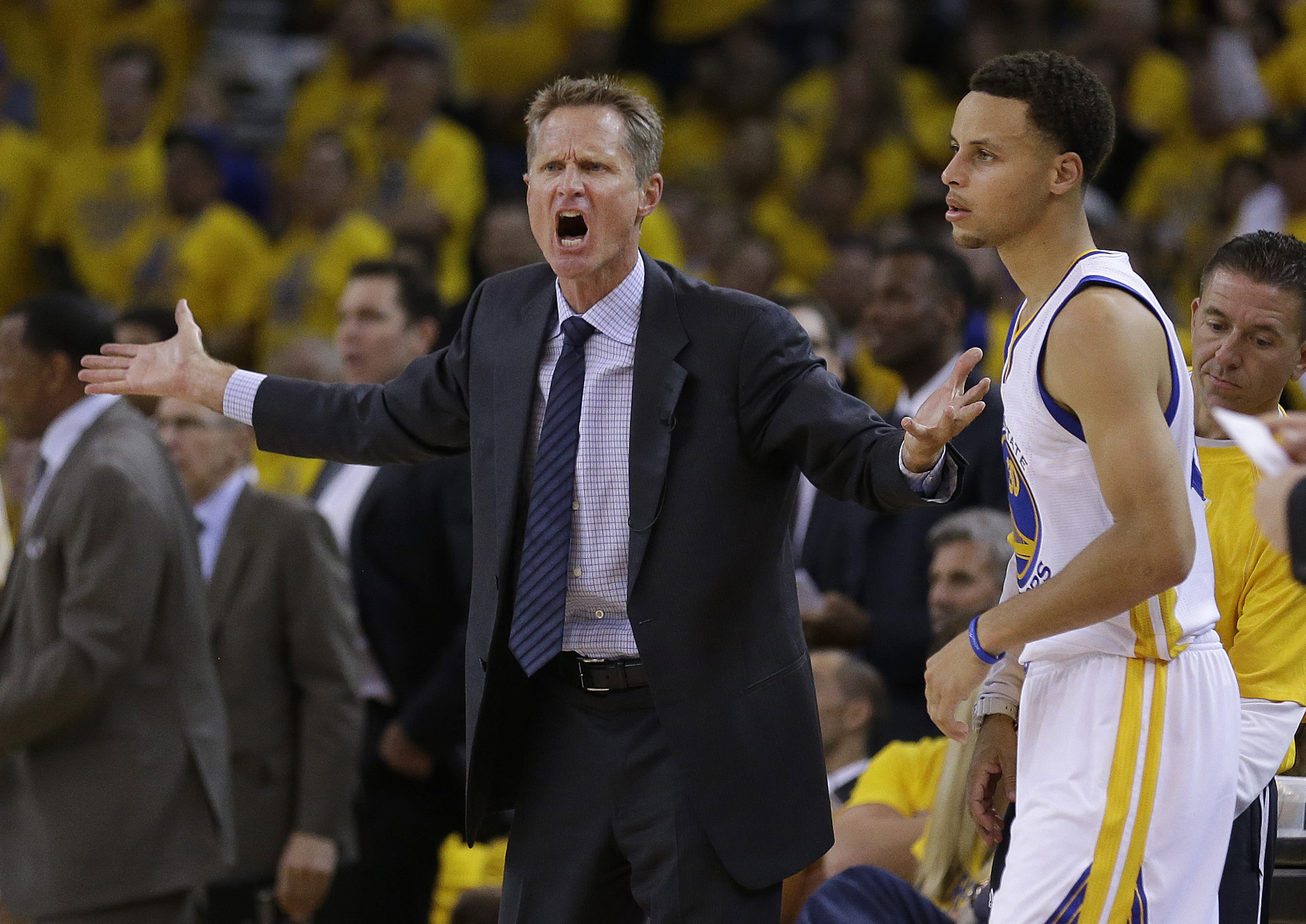 In this file photo from Tuesday, May 5, 2015, Golden State Warriors head coach Steve Kerr, left, reacts next to guard Stephen Curry during the first half of Game 2 in a second-round NBA playoff basketball series against the Memphis Grizzlies in Oakland, Calif. (Ben Margot/AP)