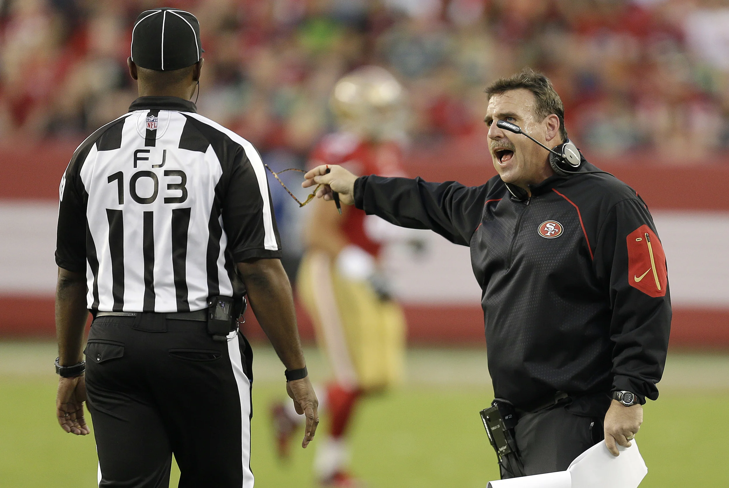 San Francisco 49ers head coach Jim Tomsula, right, talks with field judge Eugene Hall during the first half of an NFL football game against the Seattle Seahawks in Santa Clara, Calif., Thursday, Oct. 22, 2015. (Ben Margot/AP)