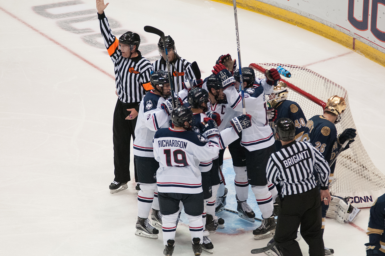 Members of the UConn men's ice hockey team are seen surrounding the Notre Dame goal during their game against the Irish at the Barclays Center in Brooklyn, New York on Sunday, Nov. 1, 2015. (Jackson Haigis/The Daily Campus)