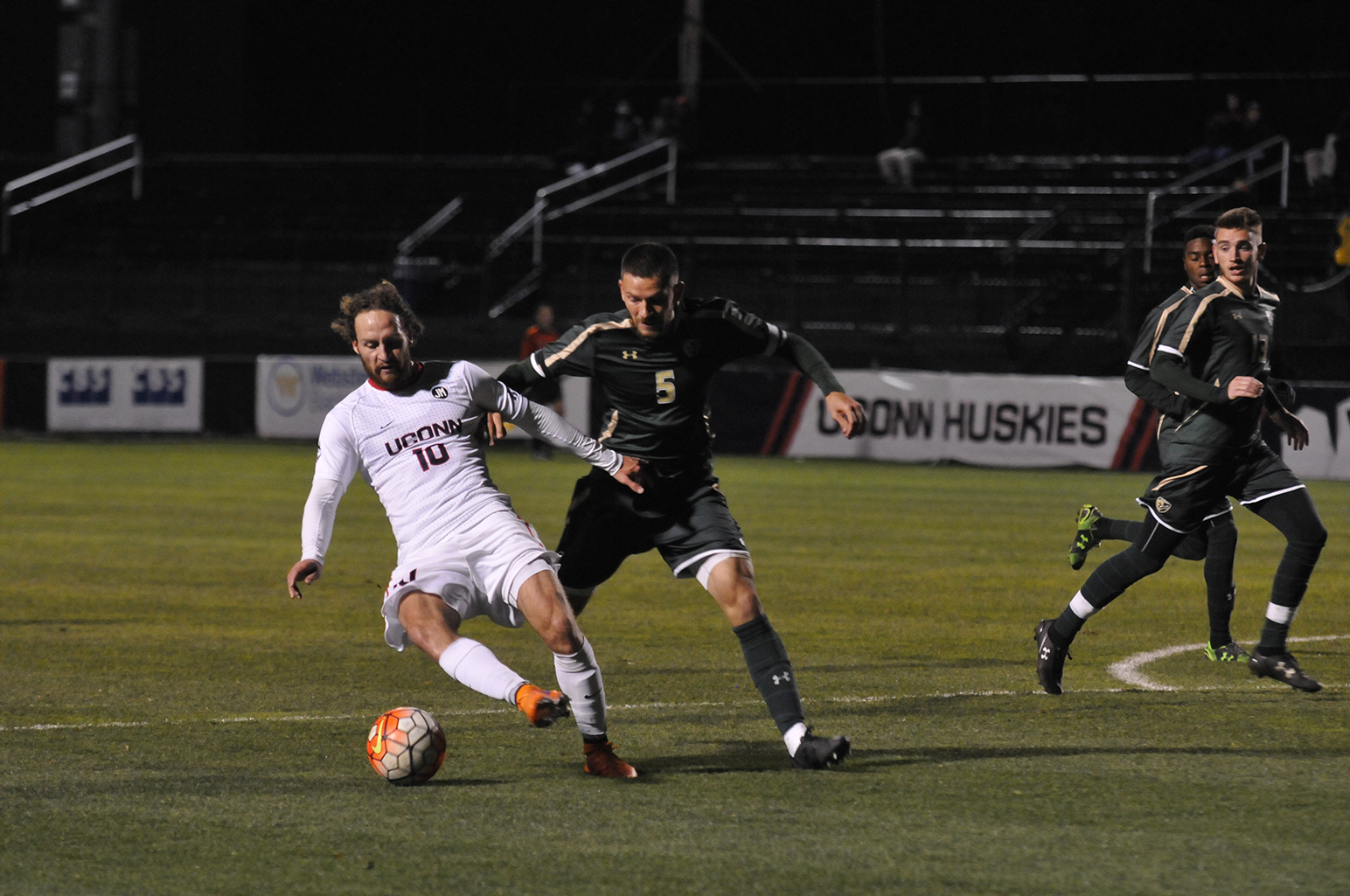 UConn junior midfielder Sebastian Brems fends off a South Florida defender during the Huskies' game against the Bulls at Joseph J. Morrone Stadium in Storrs, Connecticut on Saturday, Oct. 31, 2015. (Marissa Aldieri/The Daily Campus)