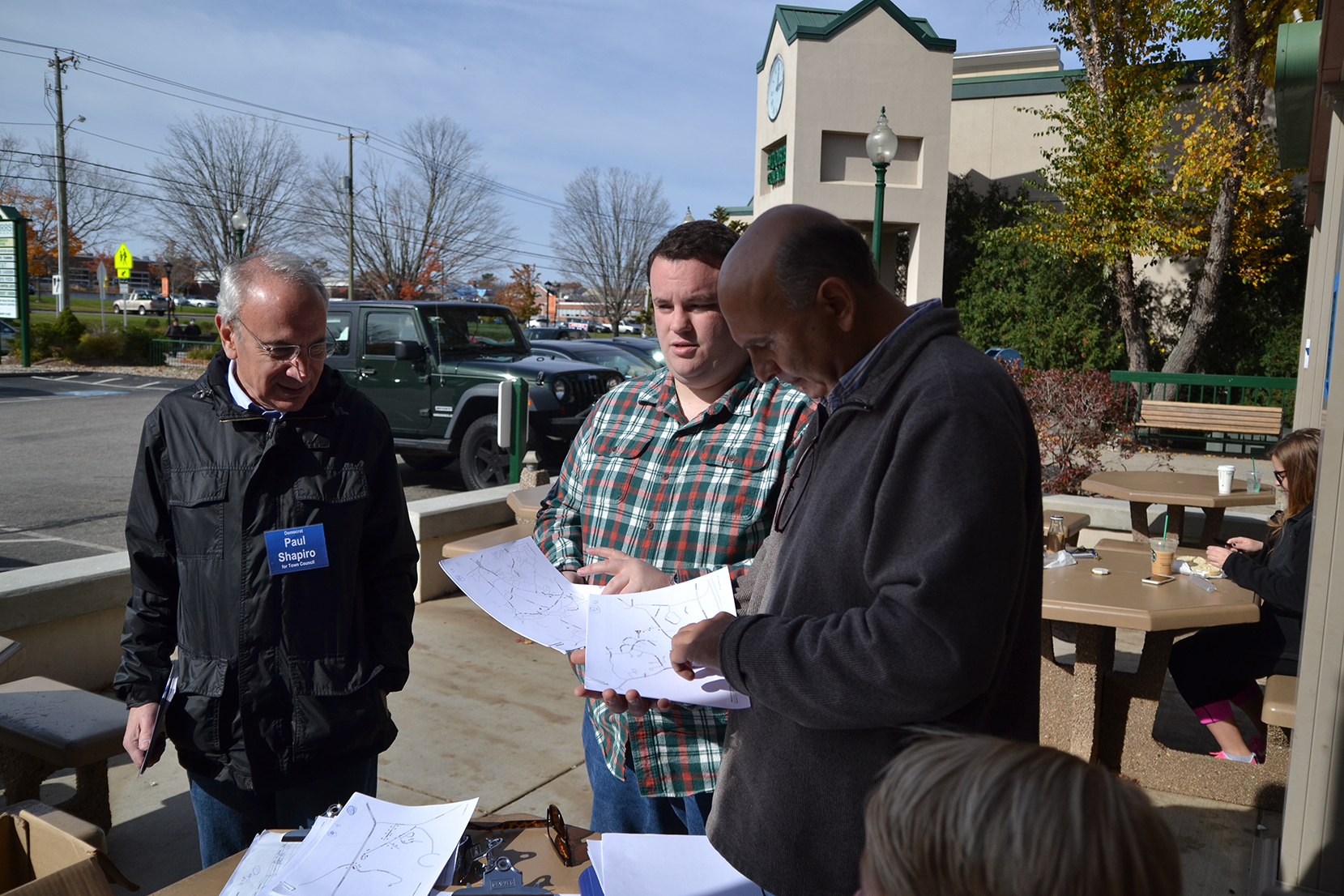 Town council member Paul Shapiro (left) and other members of Mansfield Democrats plan a campaign route in the Storrs Commons shopping area in Mansfield, Connecticut on Saturday, Oct. 31, 2015. Democrats campaigned door-to-door to raise awareness about their campaign. Election Day is Nov. 3. (Amar Batra/The Daily Campus)
