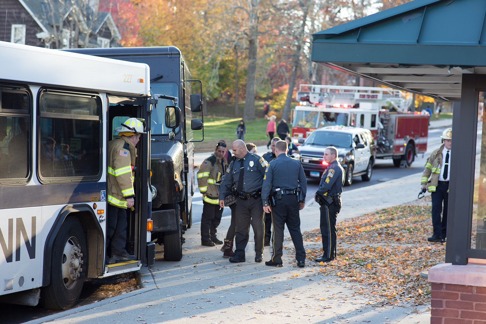 UConn police officers and fire department personnel inspect the scene of the collision between a UConn Transportation bus and a UPS deliver truck at the Arjona Westbound stop on Tuesday, Nov. 3, 2015. (Fritz Bacon/The Daily Campus) 