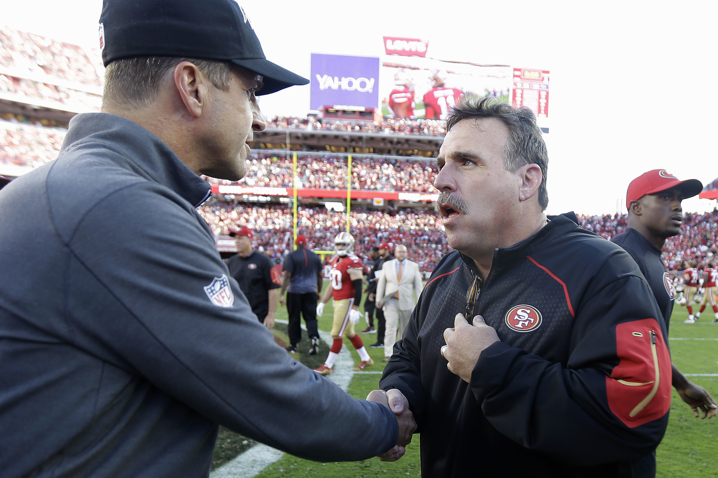 Baltimore Ravens head coach John Harbaugh, left, shakes hands with San Francisco 49ers head coach Jim Tomsula after an NFL football game in Santa Clara, Calif., Sunday, Oct. 18, 2015. The 49ers won 25-20. (Ben Margot/AP)
