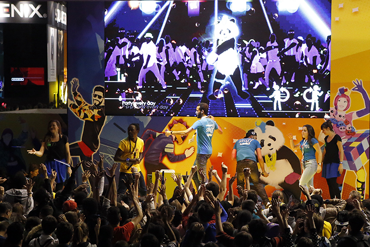 Visitors play Just Dance, a video game published by Ubisoft at the Paris Games Week, a trade fair for video games in Paris, France, Sunday, Nov. 1, 2015. Paris Games week runs from October 28 to November 1, 2015. (AP)