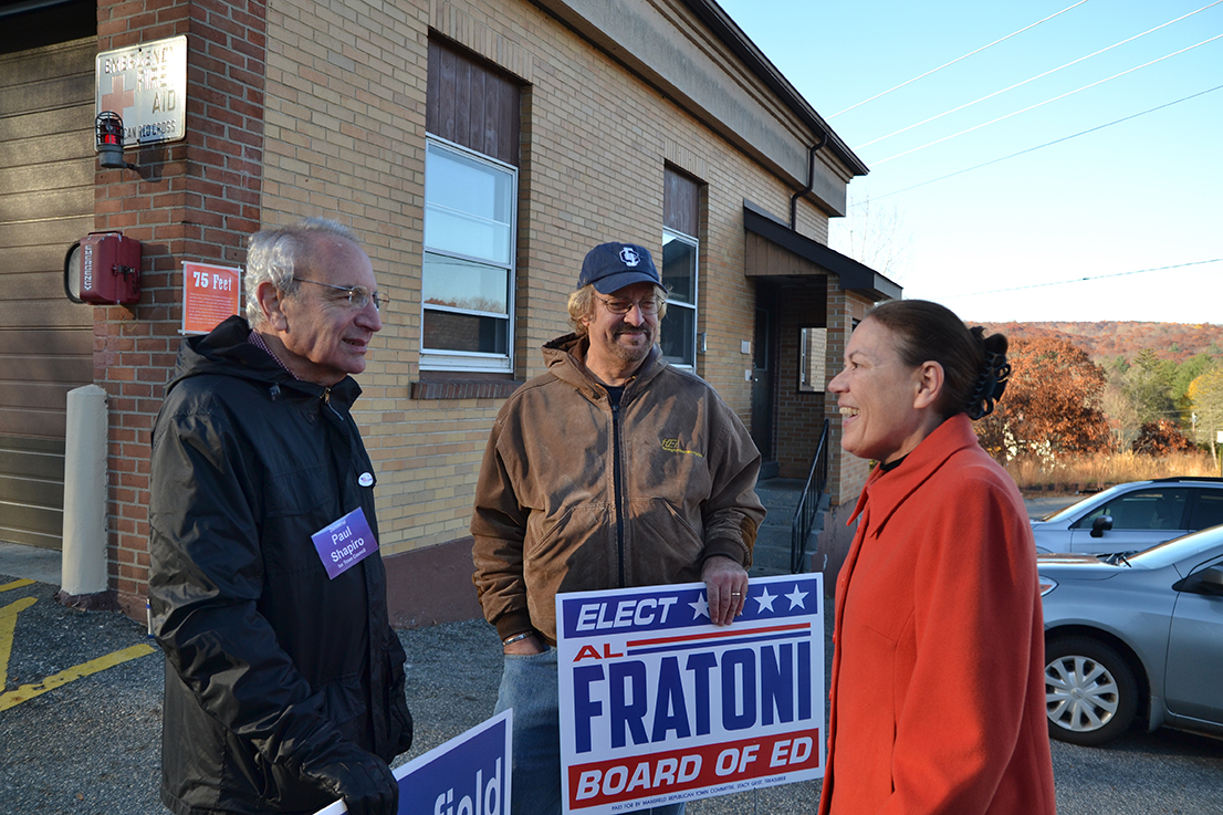 Voting locations were spread across the Town of Mansfield and included the Mansfield Community Center (District 1), Eagleville Fire Department (District 2), Mansfield Library (District 3), and the Annie E. Vinton School (District 4). Paul Shapiro (left, Deputy Mayor and Democratic Candidate), Al Fratoni (middle, Republican Board of Education candidate) and Virginia Raymond (right, Town Council member and Republican candidate) talk outside the Eagleville Fire Department. (Amar Batra/The Daily Campus)