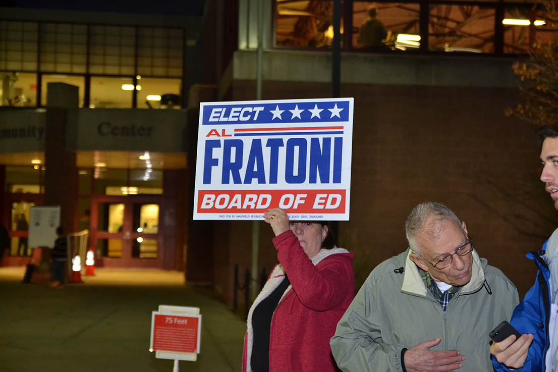 Supporters stayed at the polls well into the evening in order to potentially sway any last-minute voters. (Amar Batra/The Daily Campus)