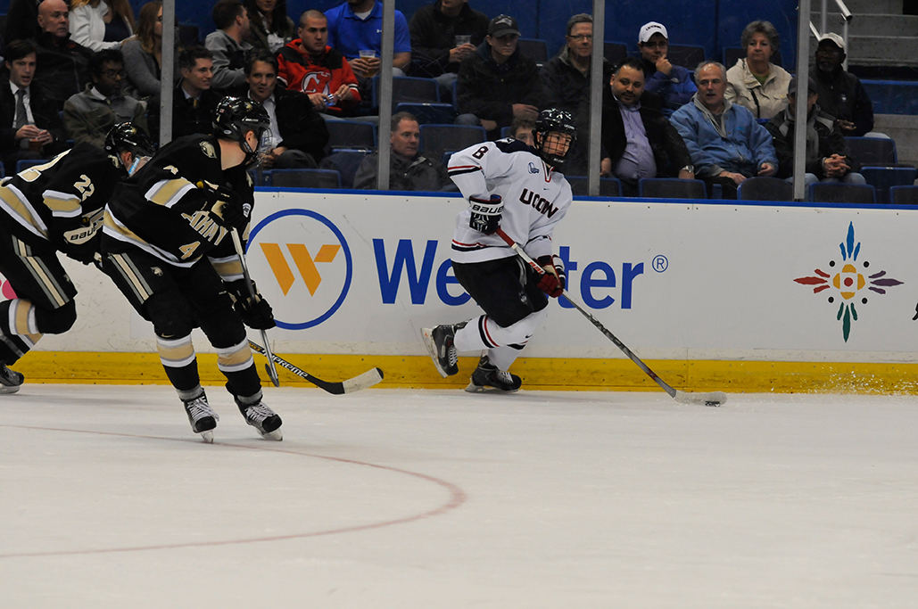 UConn sophomore forward Spencer Naas handles the puck during the Huskies' game against Army at XL Center in Hartford, Connecticut on Tuesday, Nov. 10, 2015. (Amar Batra/The Daily Campus)