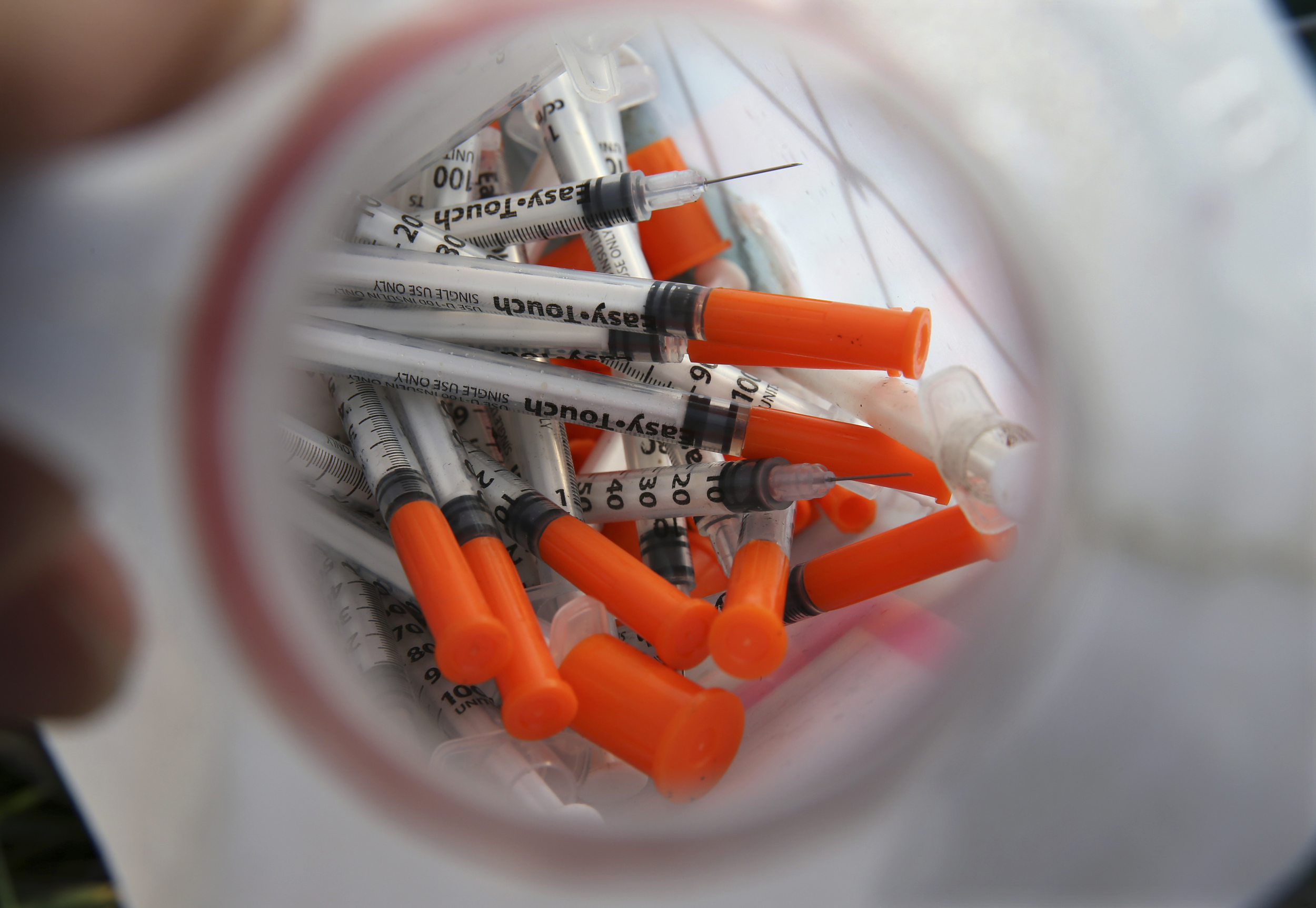 In this Thursday, Oct. 29, 2015 photograph, a jug of used needles to exchange for new is seen near an industrial area of Camden, N.J. (Mel Evans/AP)